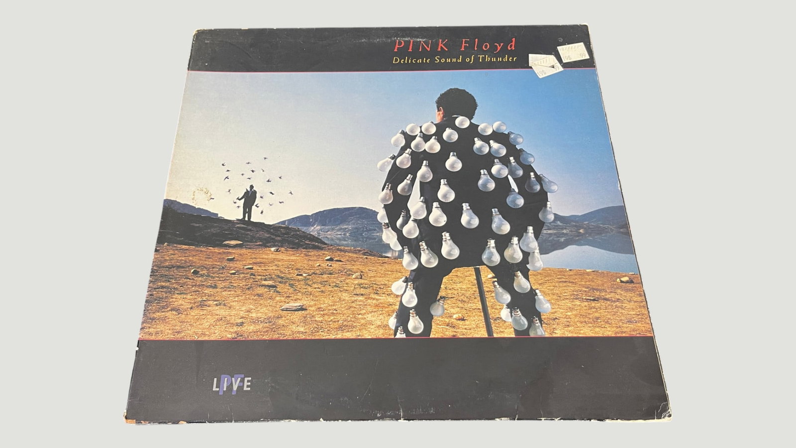 Pink Floyd – Delicate Sound of Thunder LIVE Double Vinyl LP (1988): Pink Floyd's 'Delicate Sound of Thunder' is a double live album released in 1988, recorded during the band's A Momentary Lapse of Reason Tour. The iconic cover artwork features a figure dressed in lig