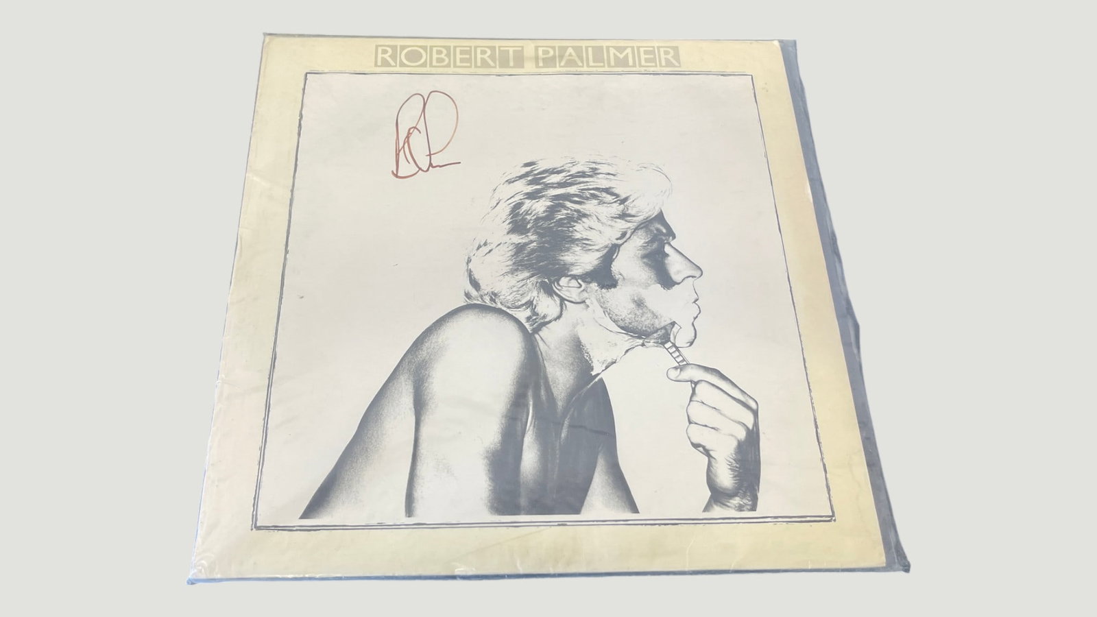 Robert Palmer Self-Titled LP Vinyl Record, Signed — Island Records c.1970s: A vinyl LP record of Robert Palmer's self-titled album, released on Island Records in the 1970s, featuring the iconic black-and-white cover art of Palmer in profile. The album cover bears what appears