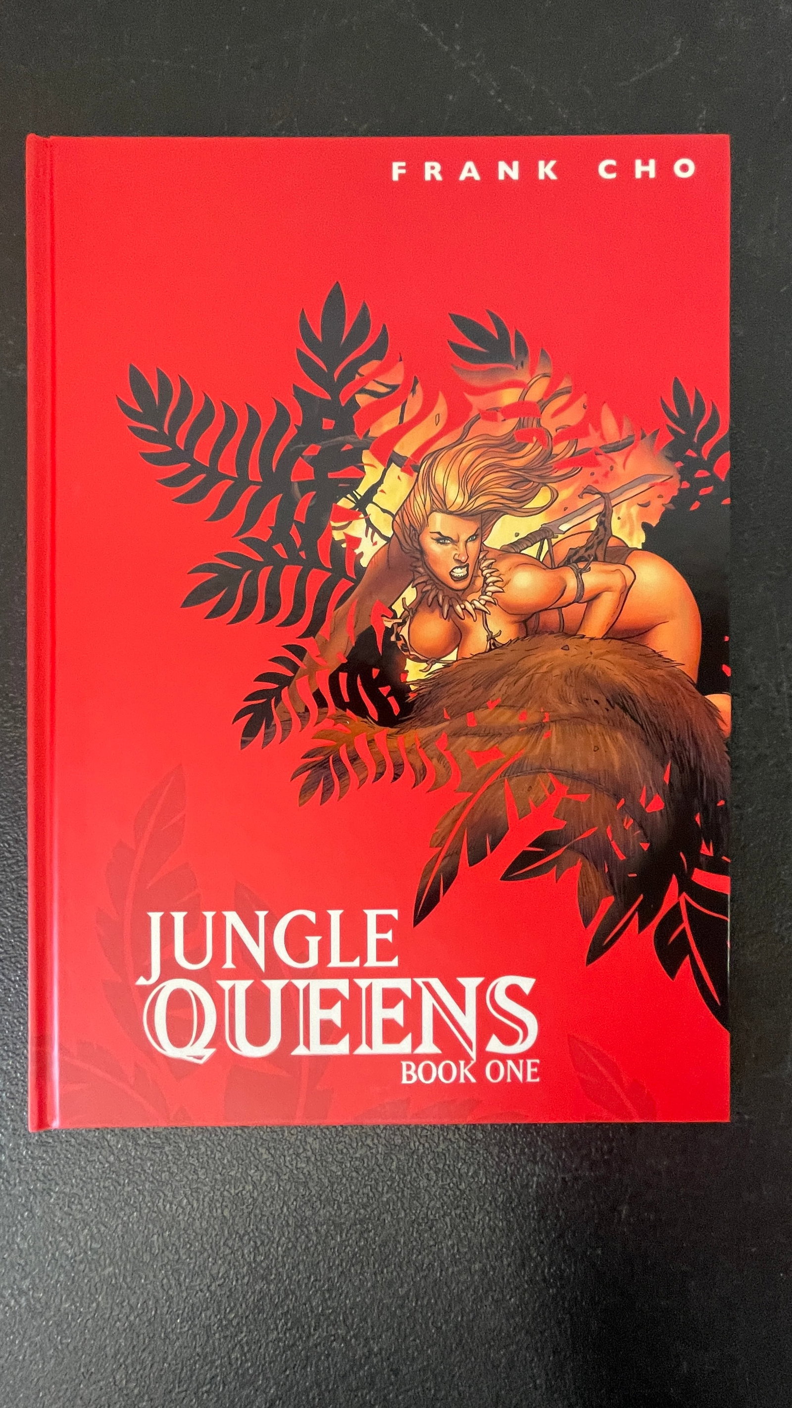 Signed Book Frank Cho 'Jungle Queens Book One' Hardcover Graphic Novel: Signed Jungle Queens Book One is a hardcover graphic novel by acclaimed artist and writer Frank Cho, known for his distinctive pin-up influenced illustration style and work on titles such as Liberty M