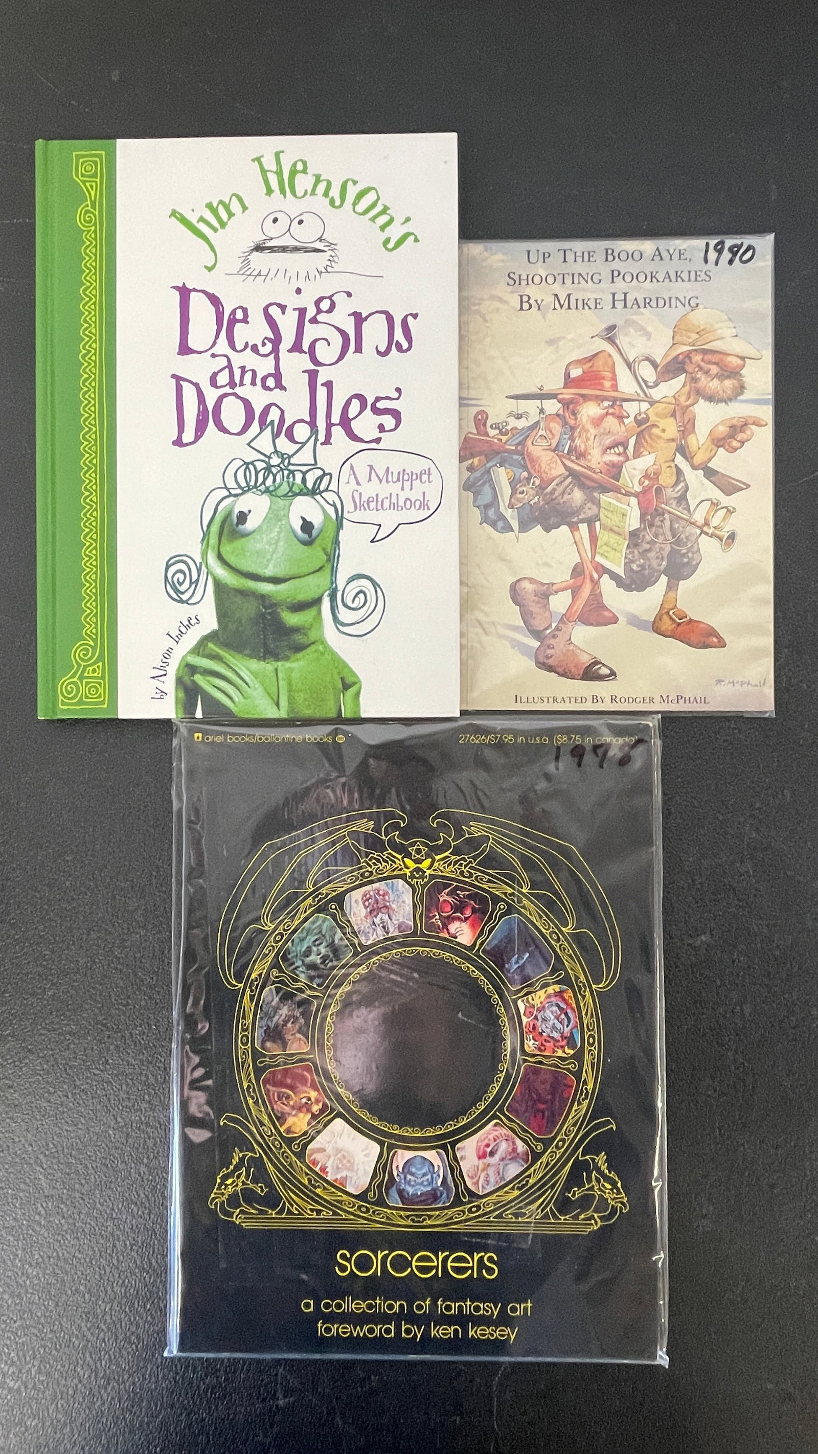Jim Henson's Designs & Doodles, Sorcerers Fantasy Art & Mike Harding Book Lot: A collection of three illustrated books: 'Jim Henson's Designs and Doodles: A Muppet Sketchbook' by Alison Inches (Abrams), a charming behind-the-scenes look at Muppet character design; 'Sorcerers: A 