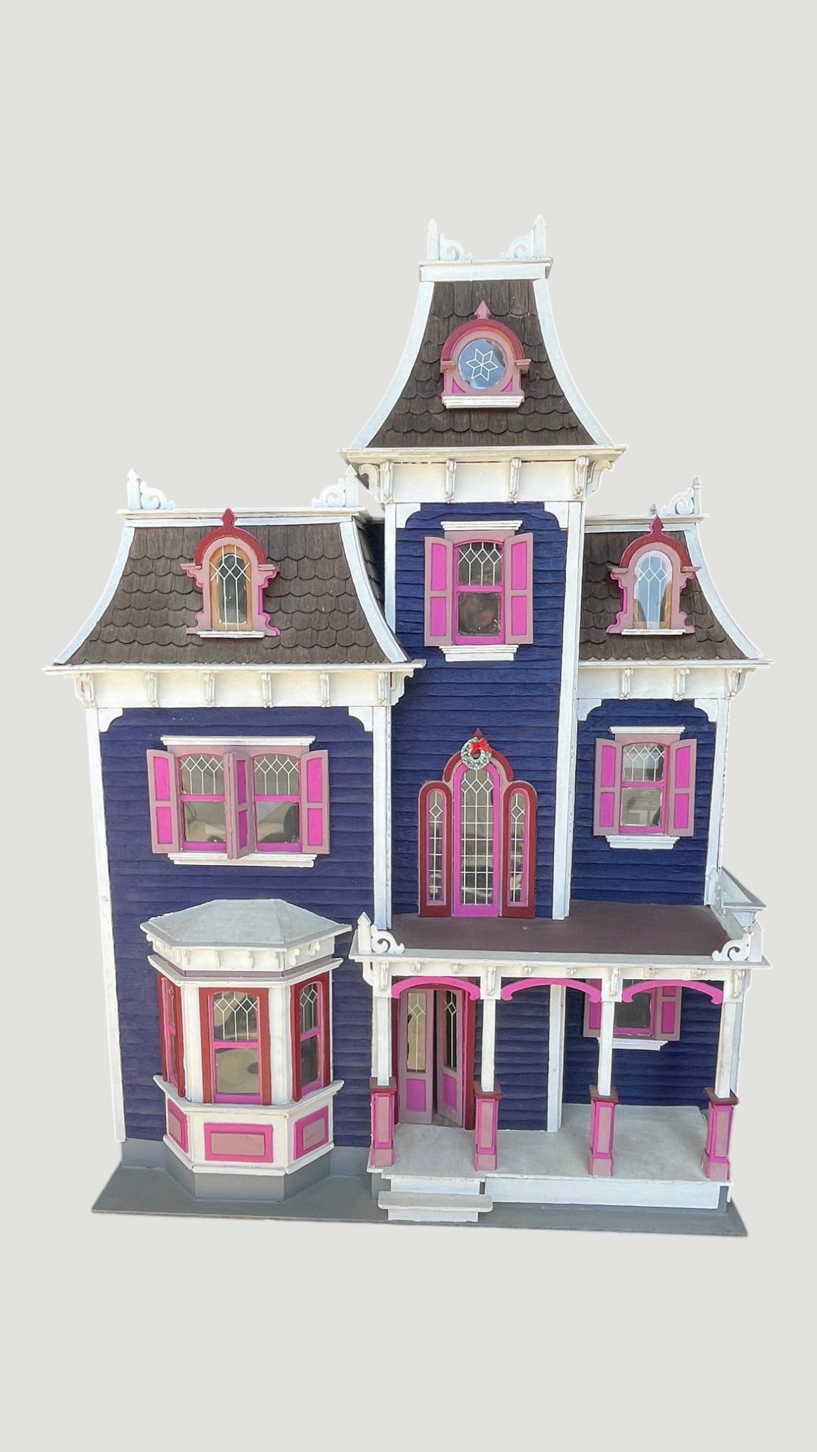 Large Victorian Wooden Dollhouse, Hand-Painted Purple & Pink, 3-Story with Tower: An impressive three-story Victorian-style wooden dollhouse featuring a distinctive mansard roof with individual shingle detailing, a central tower with decorative finials, and a wrap-around front porc