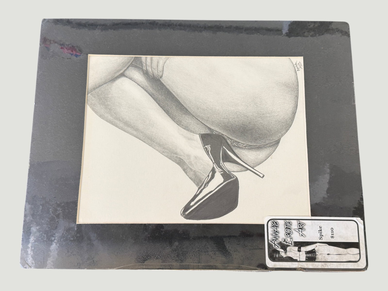 Anna's Erotic Art 'Spike' Original Pencil Drawing — Matted Artwork: An original pencil drawing titled 'Spike' by Anna's Erotic Art, depicting a detailed graphite study of legs and a stiletto high-heel shoe rendered in a realistic style. The artwork is matted on a dark