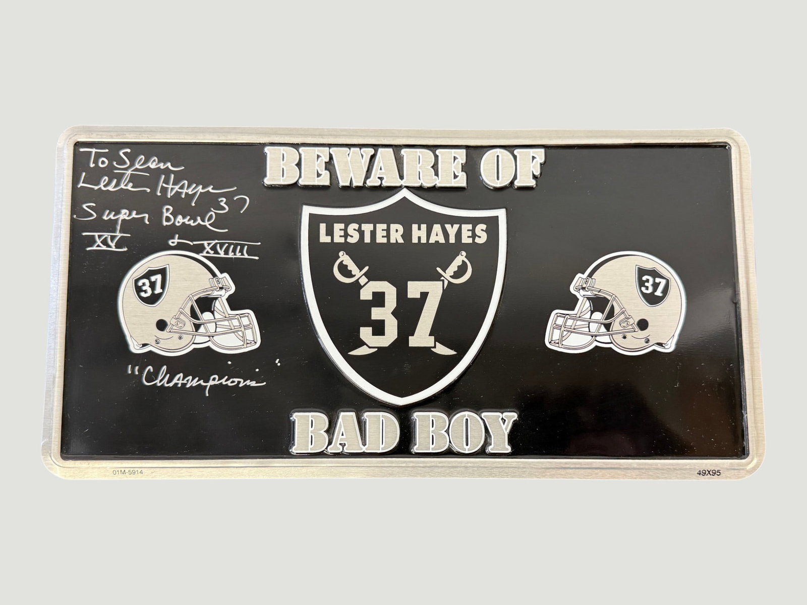 Lester Hayes #37 Raiders 'Beware of Bad Boy' Signed License Plate Novelty: A novelty license plate dedicated to Oakland Raiders cornerback Lester Hayes, featuring his name, number 37, and the Raiders shield logo flanked by two helmets, with the slogan 'Beware of Bad Boy.' Th