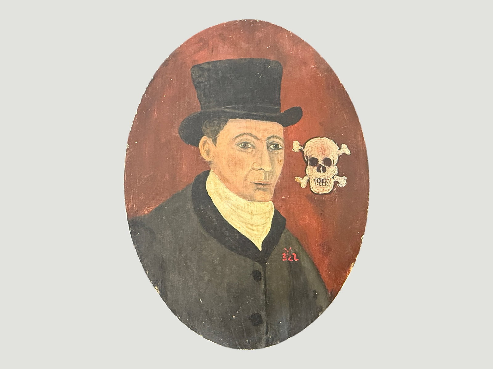 Antique Folk Art Oval Portrait Painting, Man in Top Hat with Memento Mori Skull: A naive folk art oval portrait painting depicting a gentleman wearing a black top hat and dark coat with a cream cravat, set against a deep red background. Notably featuring a skull and crossbones mot