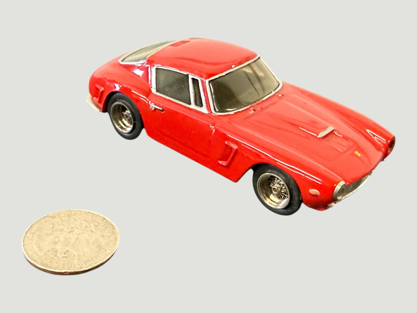 Vintage Die-Cast Ferrari 250 GT Berlinetta Red Scale Model Car, c.1960s: A vintage die-cast scale model of the iconic Ferrari 250 GT Berlinetta, finished in classic Rosso Corsa red with white window surrounds and detailed chrome wire-spoke wheels. The model appears to be a