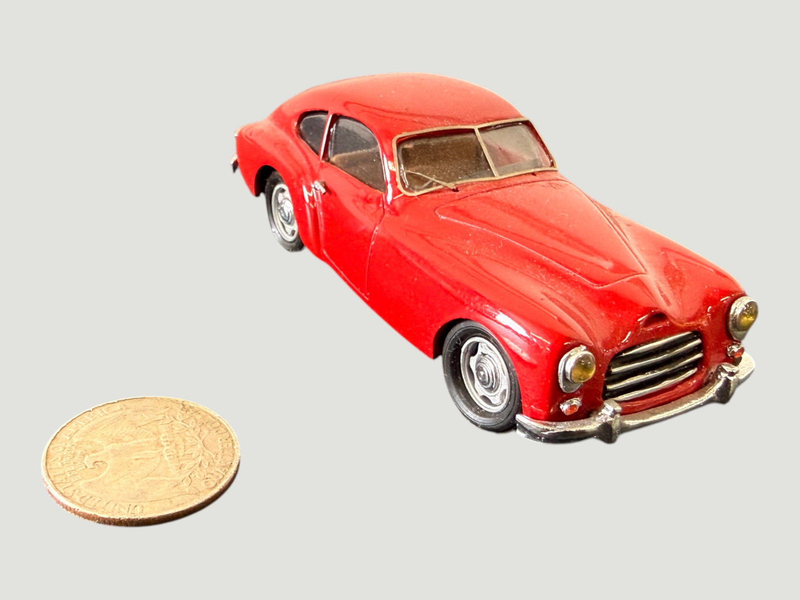 Vintage Miniature Die-Cast Red Sports Coupe Model Car, c.1950s-60s, 1:43 Scale: A small-scale die-cast metal model car depicting a classic European sports coupe of the early 1950s style, likely representing a vehicle such as a Delahaye, Talbot-Lago, or similar French/Italian gran