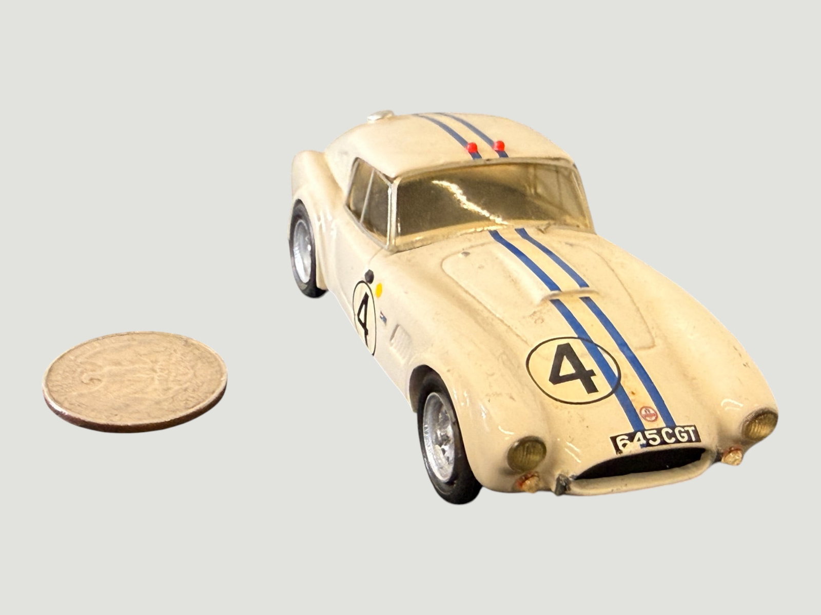Dinky/Corgi Style Diecast Racing Car Model #4 '645 CGT' AC Cobra/Ferrari GT 1:43: A small-scale diecast model racing car finished in cream/white with blue racing stripes and racing number 4 roundel markings, bearing the registration plate '645 CGT'. The model appears to represent a