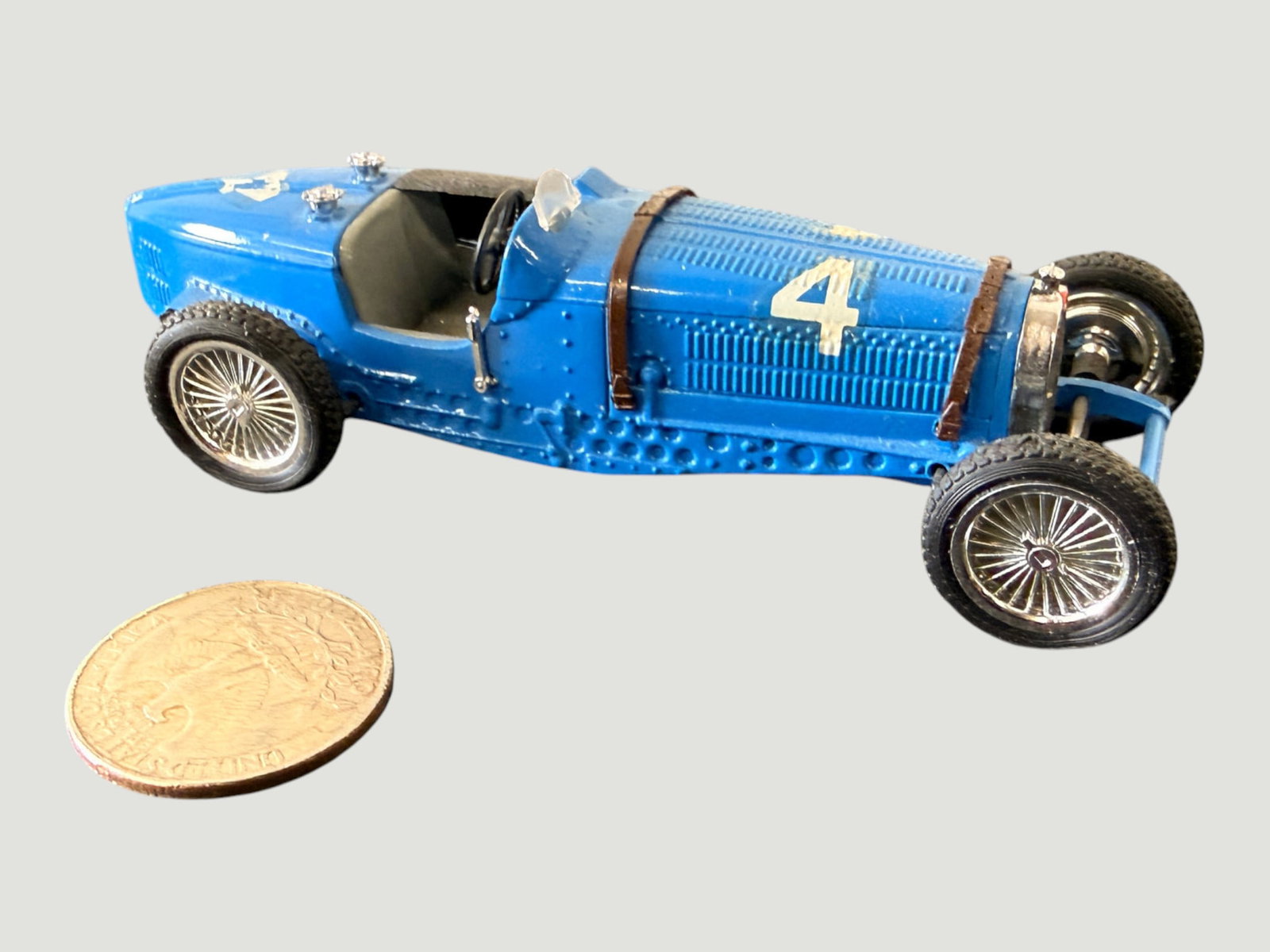Bburago Bugatti Type 59 No.4 Blue Diecast Scale Model Racing Car 1:18: A diecast scale model of the classic Bugatti Type 59 Grand Prix racing car, finished in the iconic French Racing Blue livery and bearing race number 4. The model features highly detailed wire-spoke wh