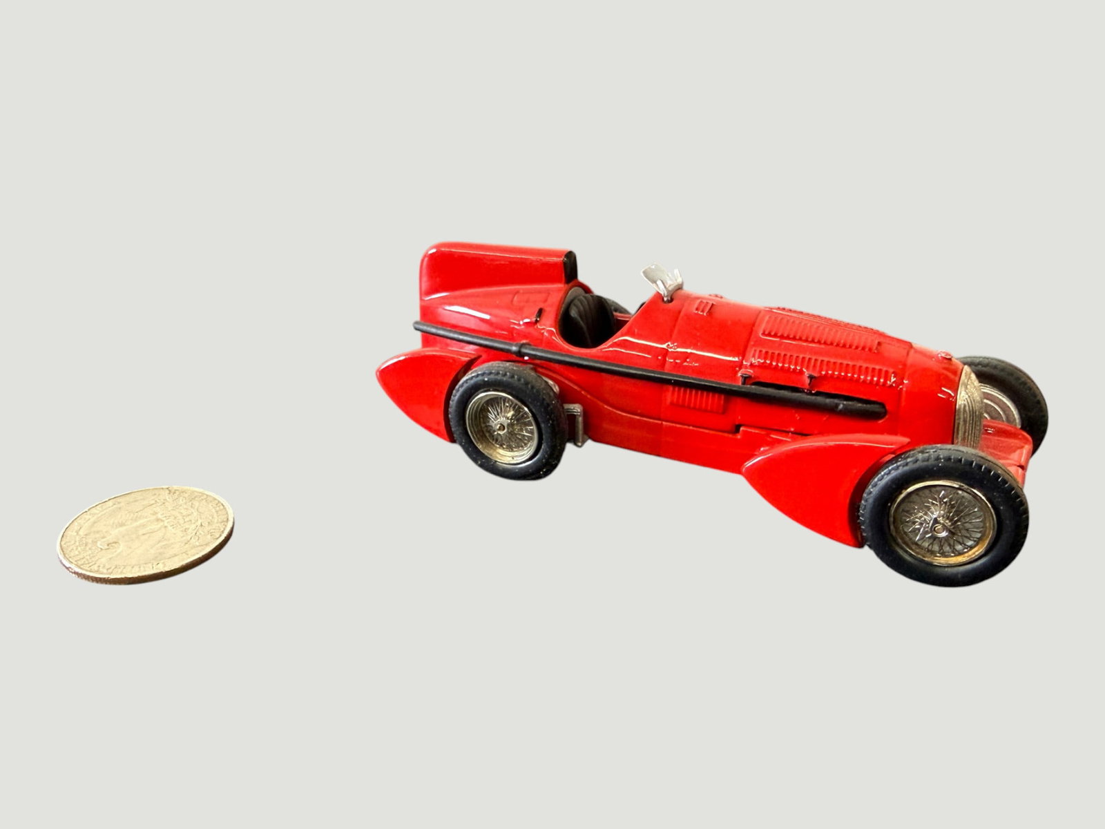 Vintage Diecast Red Racing Car Model, Alfa Romeo 8C Style, c.1950s-1960s: A detailed diecast scale model of a vintage grand prix racing car, finished in bright red with black rubber tyres and intricate spoked wire wheel hubs in gold tone. The design closely resembles a pre-