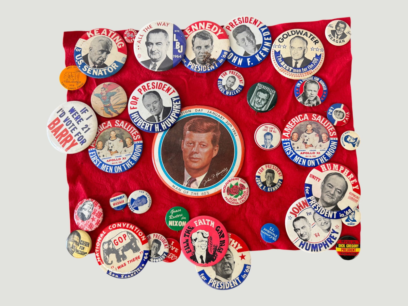 Collection of ~35 Vintage US Political Campaign Pinback Buttons 1960s Era: A substantial grouping of approximately 35 vintage American political campaign pinback buttons spanning primarily the 1960s era, displayed on a red cloth background. The collection features buttons fo