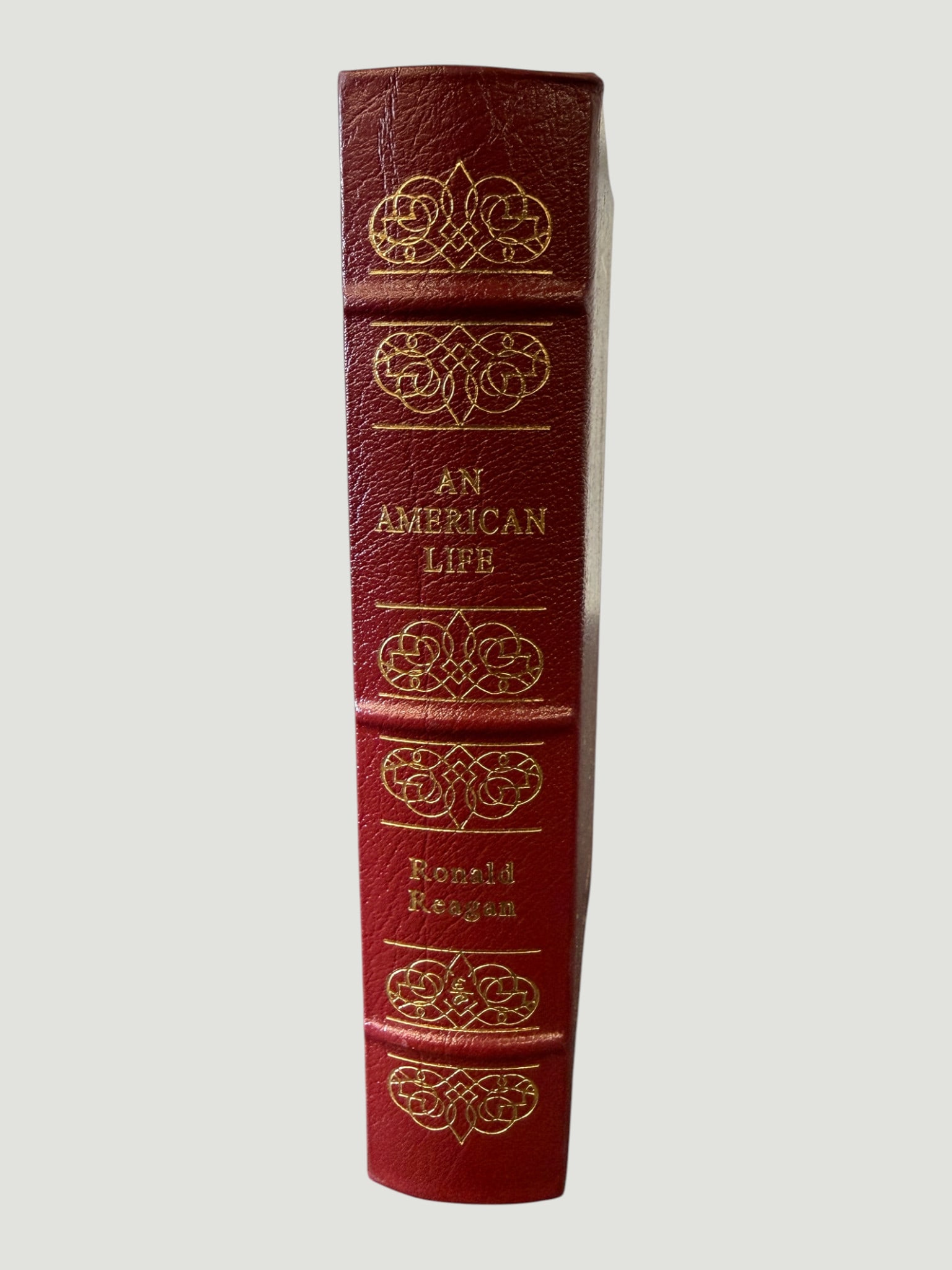Ronald Reagan 'An American Life' Easton Press Leather Bound Edition: A deluxe leather-bound edition of Ronald Reagan's autobiography 'An American Life,' published by Easton Press, featuring their signature full burgundy leather binding with 22-karat gold gilt decorativ