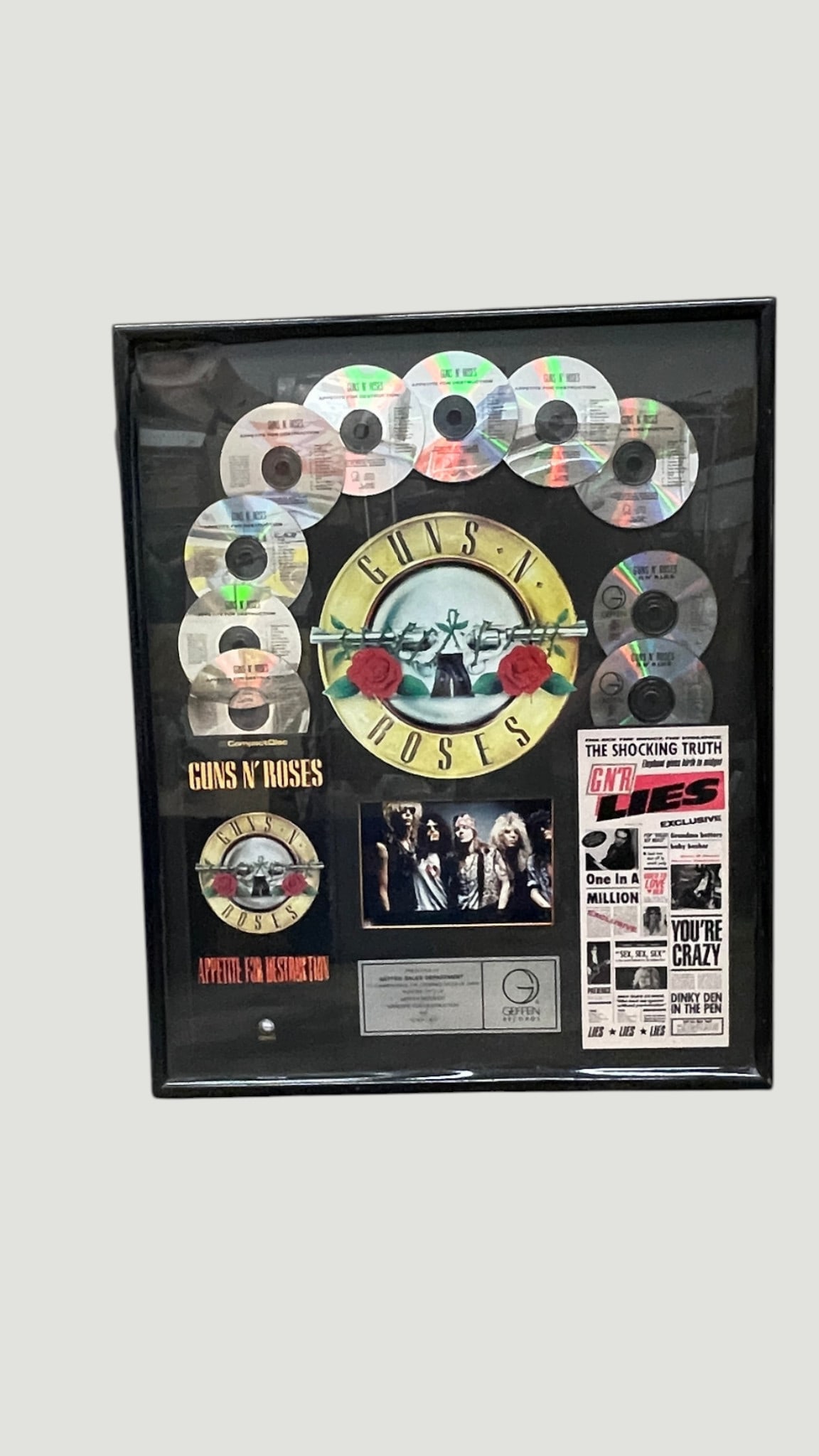 Guns N' Roses Multi-Platinum CD Award Display — Appetite for Destruction & GN'R Lies: A framed Guns N' Roses sales achievement display award issued by Geffen Records, featuring multiple compact discs from 'Appetite for Destruction' and 'GN'R Lies' arranged around the iconic band logo. 