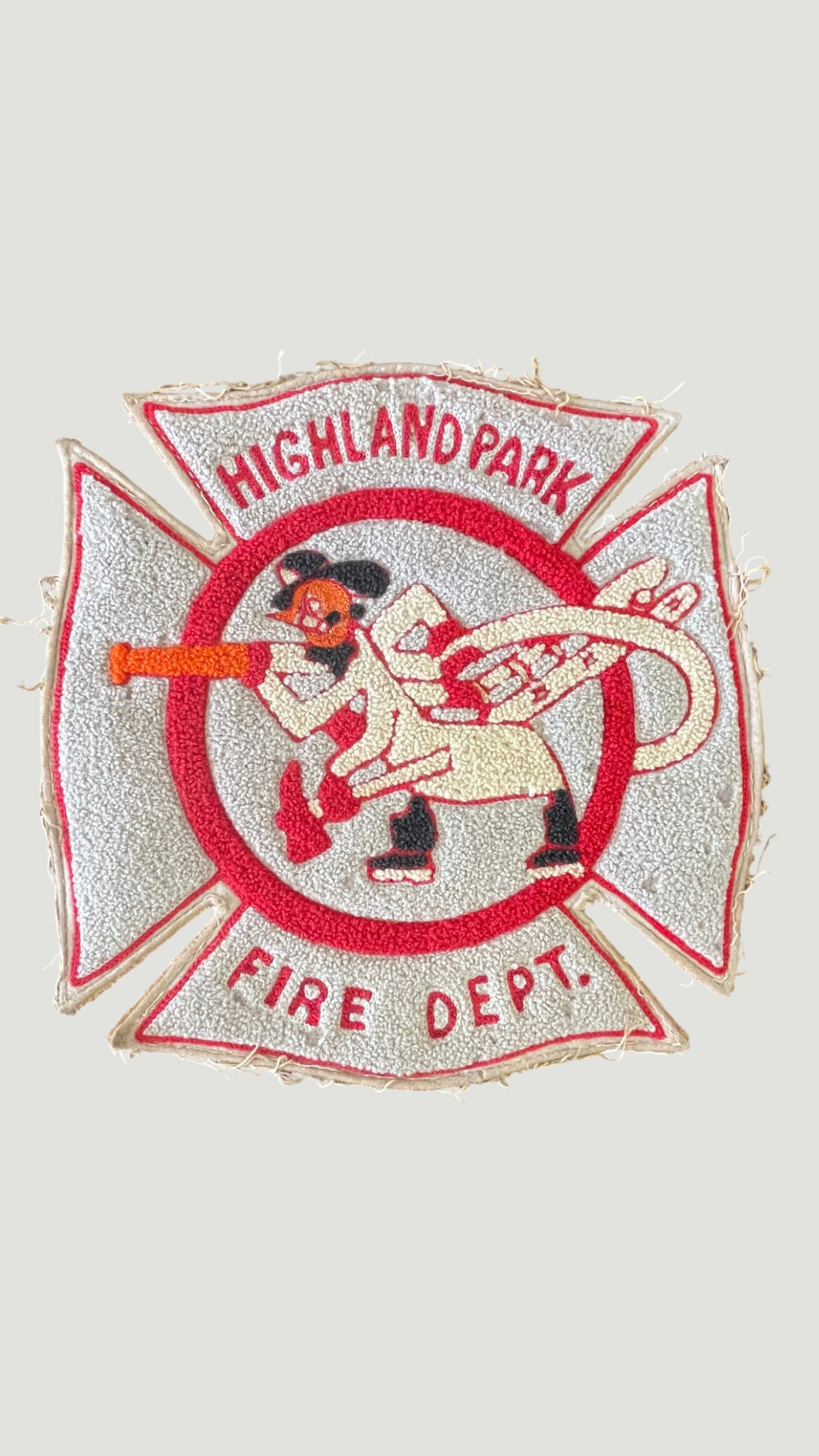 Highland Park Fire Department Embroidered Maltese Cross Patch — Vintage: A vintage embroidered uniform patch from the Highland Park Fire Department, shaped in the traditional Maltese Cross form used widely by fire service organizations. The patch features a central circula