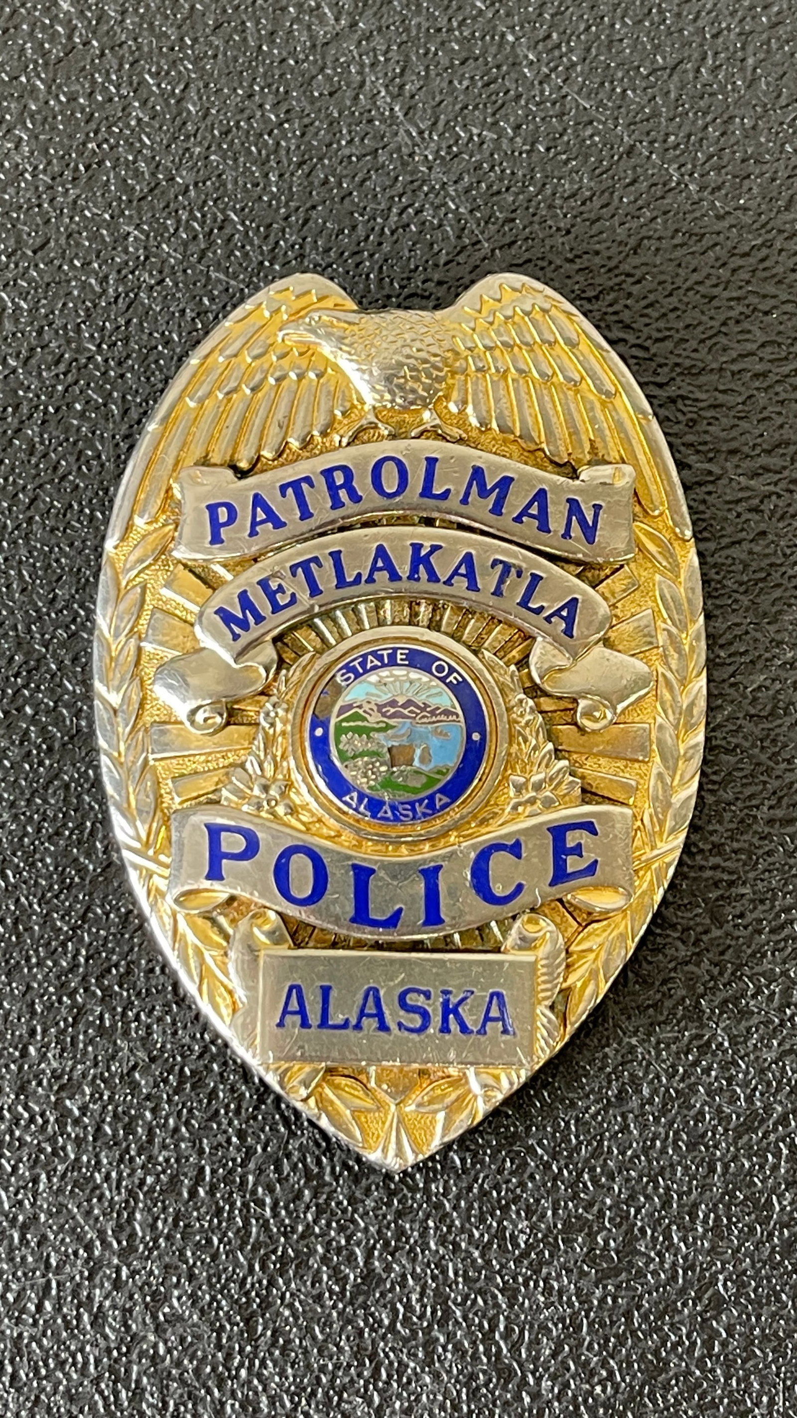 Metlakatla Police Patrolman Badge, Alaska — Gold-Tone Oval Shield with State Seal (1 of 3)