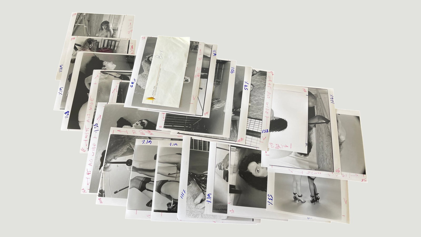 Vintage Black & White Photography Press Prints Collection with Crop Marks c.1980s: A collection of approximately 20-25 vintage black and white photographic prints, appearing to be professional press or editorial photographs from circa the 1980s, featuring fashion and glamour subject