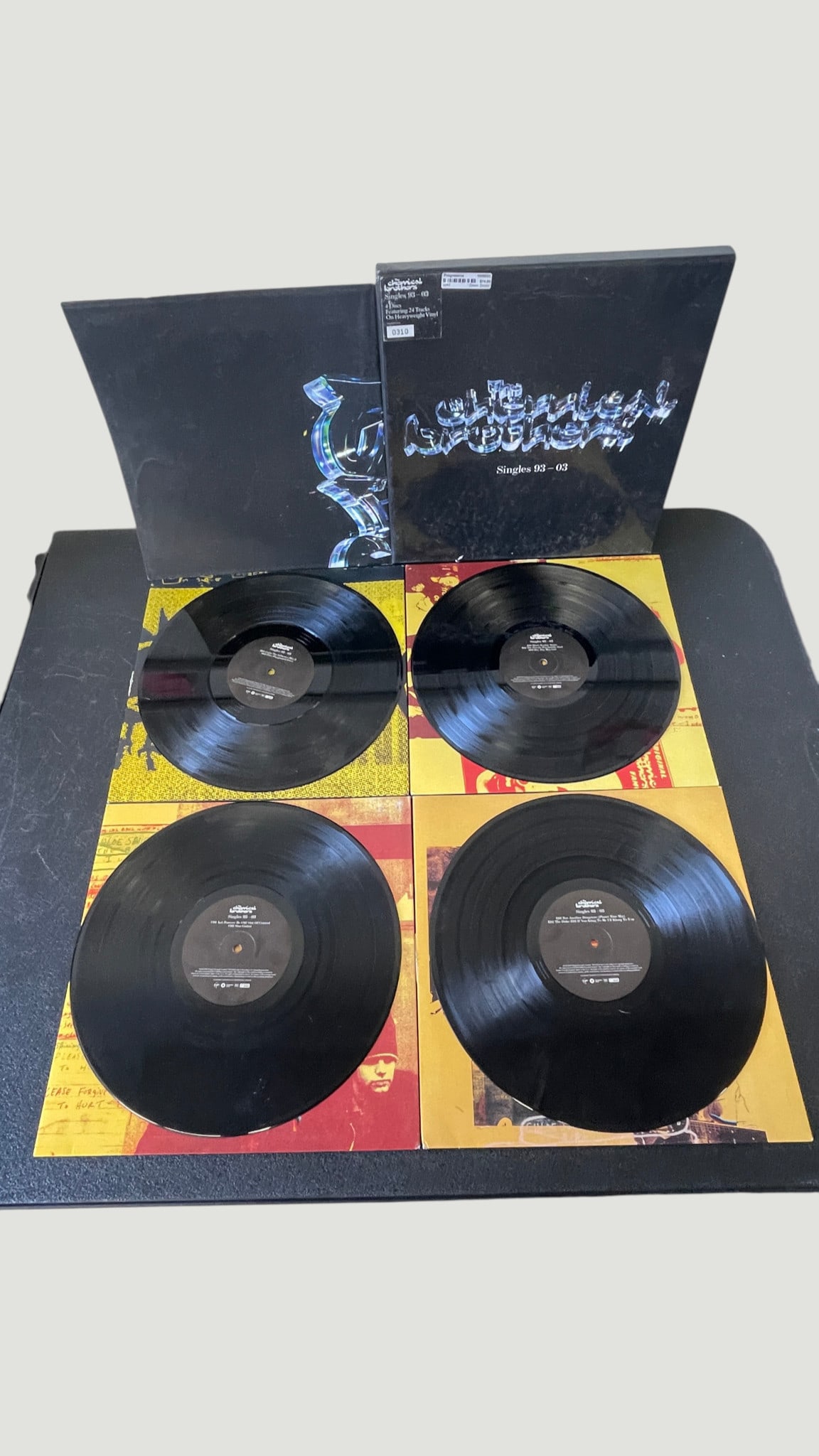 The Chemical Brothers – Singles 93-03 4xLP Vinyl Box Set (2003): A limited numbered box set by The Chemical Brothers titled 'Singles 93-03,' released in 2003 on Virgin/Freestyle Dust Records. The set comprises four heavyweight vinyl LPs containing 24 tracks spannin