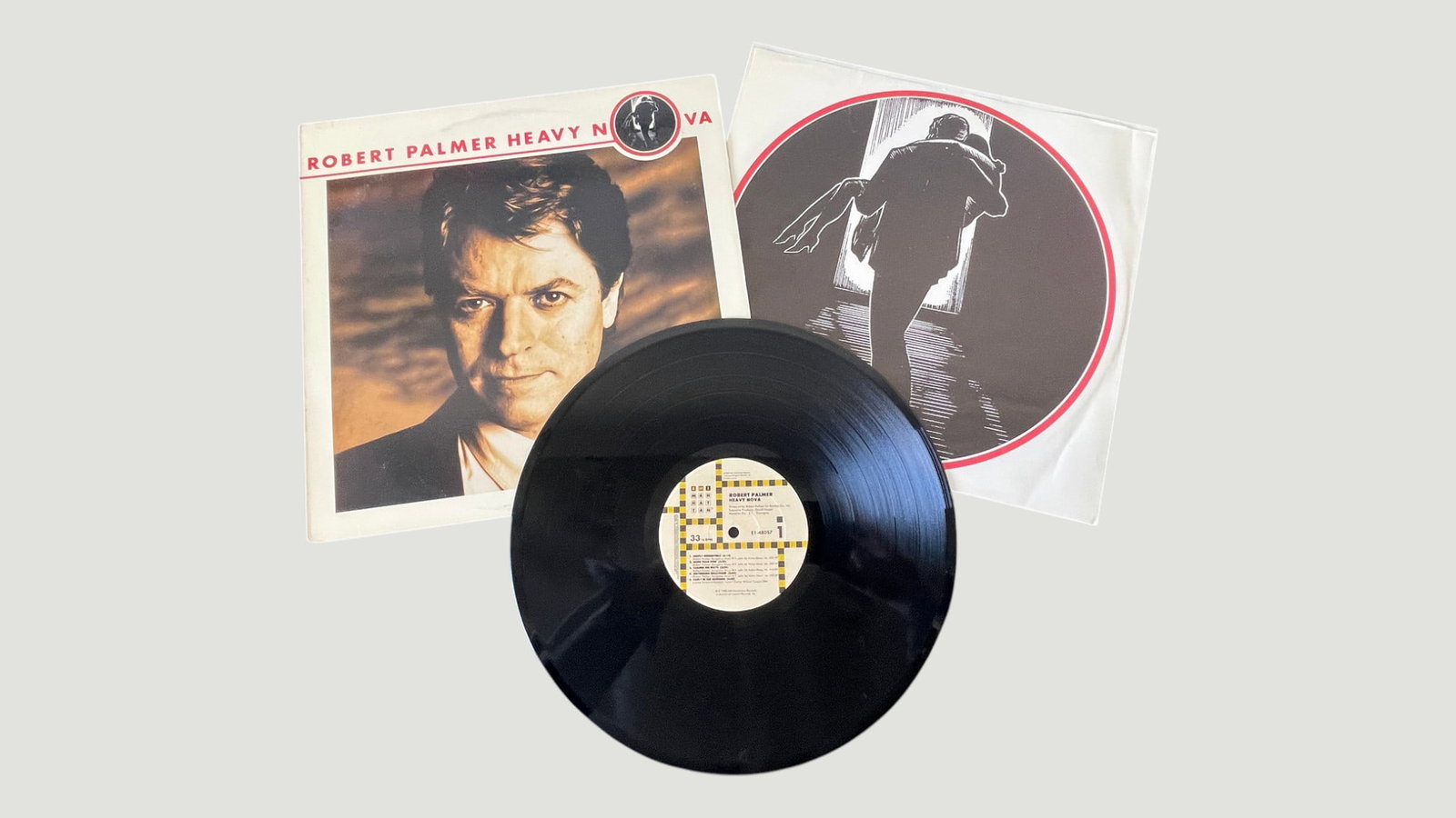 Robert Palmer 'Heavy Nova' Vinyl LP Record, EMI Manhattan, 1988: Robert Palmer's 1988 studio album 'Heavy Nova' presented as a complete vinyl LP package on the EMI Manhattan label, catalogue number E1-48032, pressed at 33 RPM. The set includes the album sleeve feat