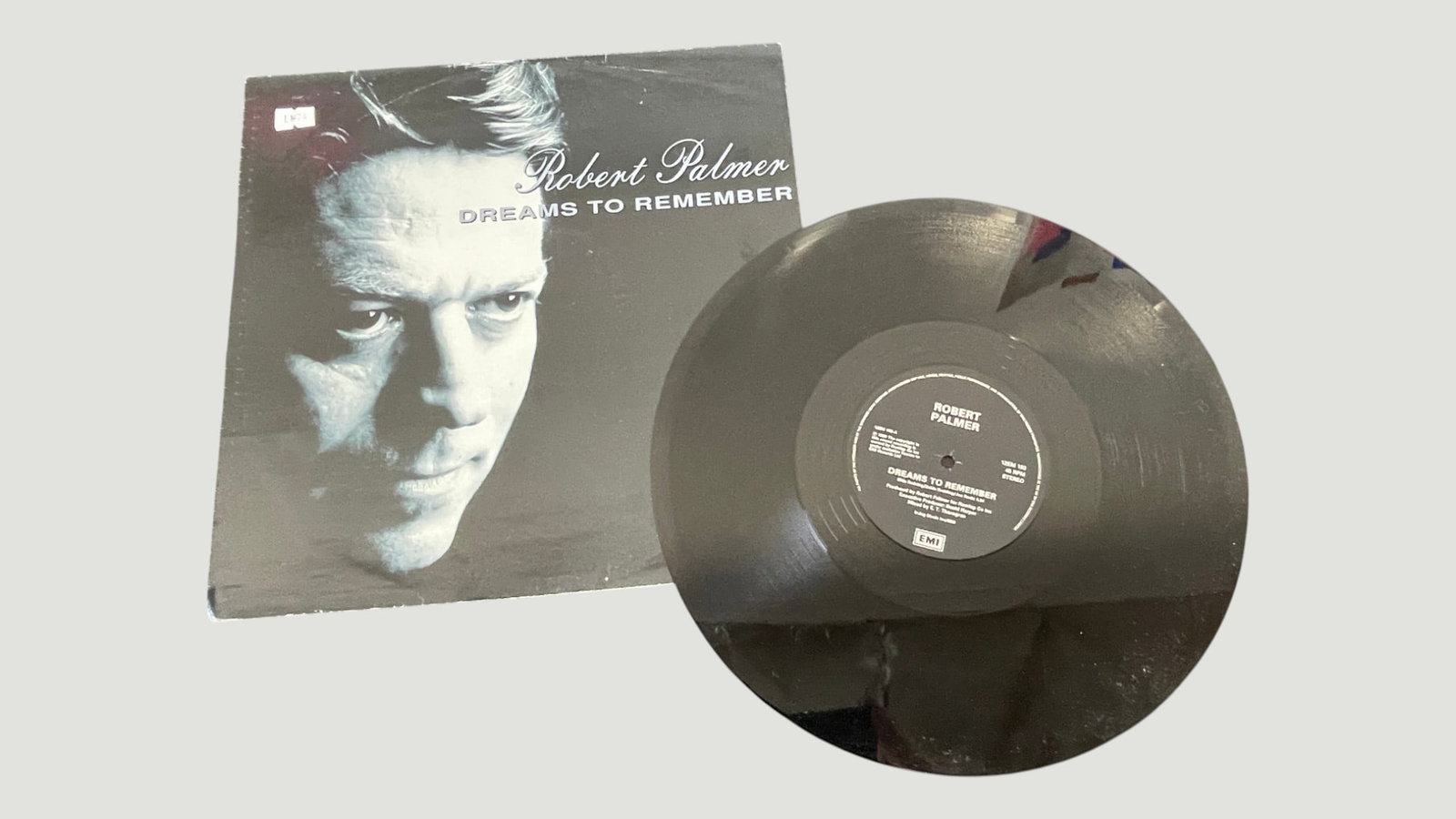 Robert Palmer 'Dreams To Remember' 12" Vinyl Single EMI Records: A 12-inch vinyl single of 'Dreams To Remember' by Robert Palmer, released on EMI Records and pressed at 45 RPM in stereo. Robert Palmer was a celebrated British rock and soul artist known for hits suc