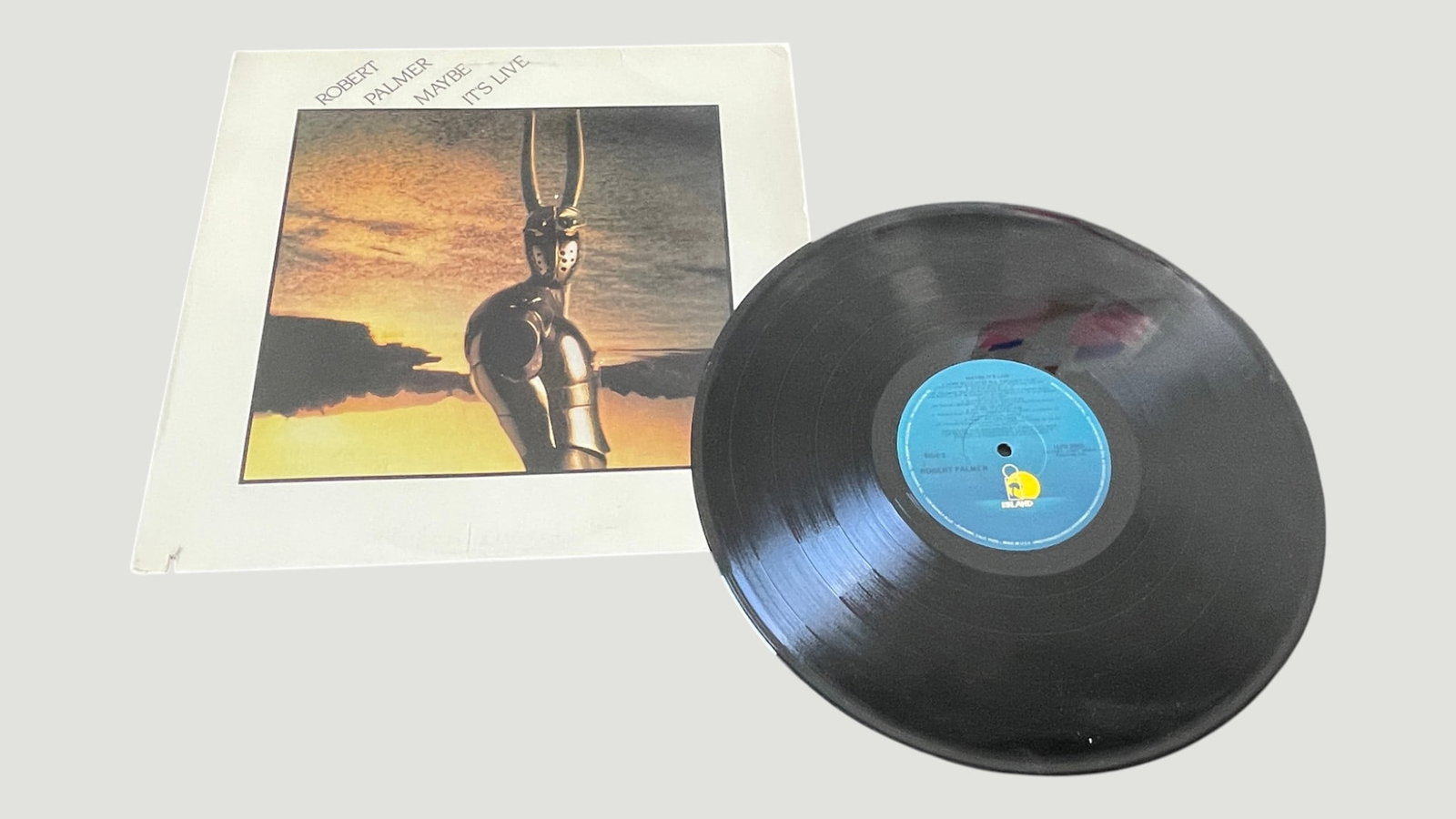 Robert Palmer 'Maybe It's Live' Vinyl LP Island Records 1983: Robert Palmer 'Maybe It's Live' is a live album released in 1983 on Island Records, featuring performances from Palmer's tours supporting his studio albums. The record features the distinctive blue Is