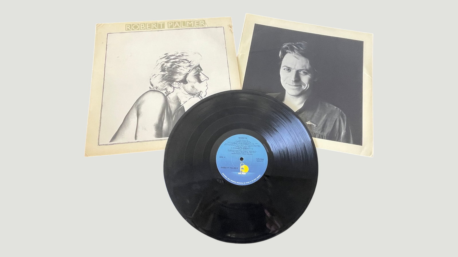 Robert Palmer 'Secrets' Vinyl LP Record, Island Records, 1979: Robert Palmer's 'Secrets' album released on Island Records (catalog ILPS 9544), presented as a 12-inch vinyl LP with the distinctive blue and yellow Island Records label. This 1979 release features no
