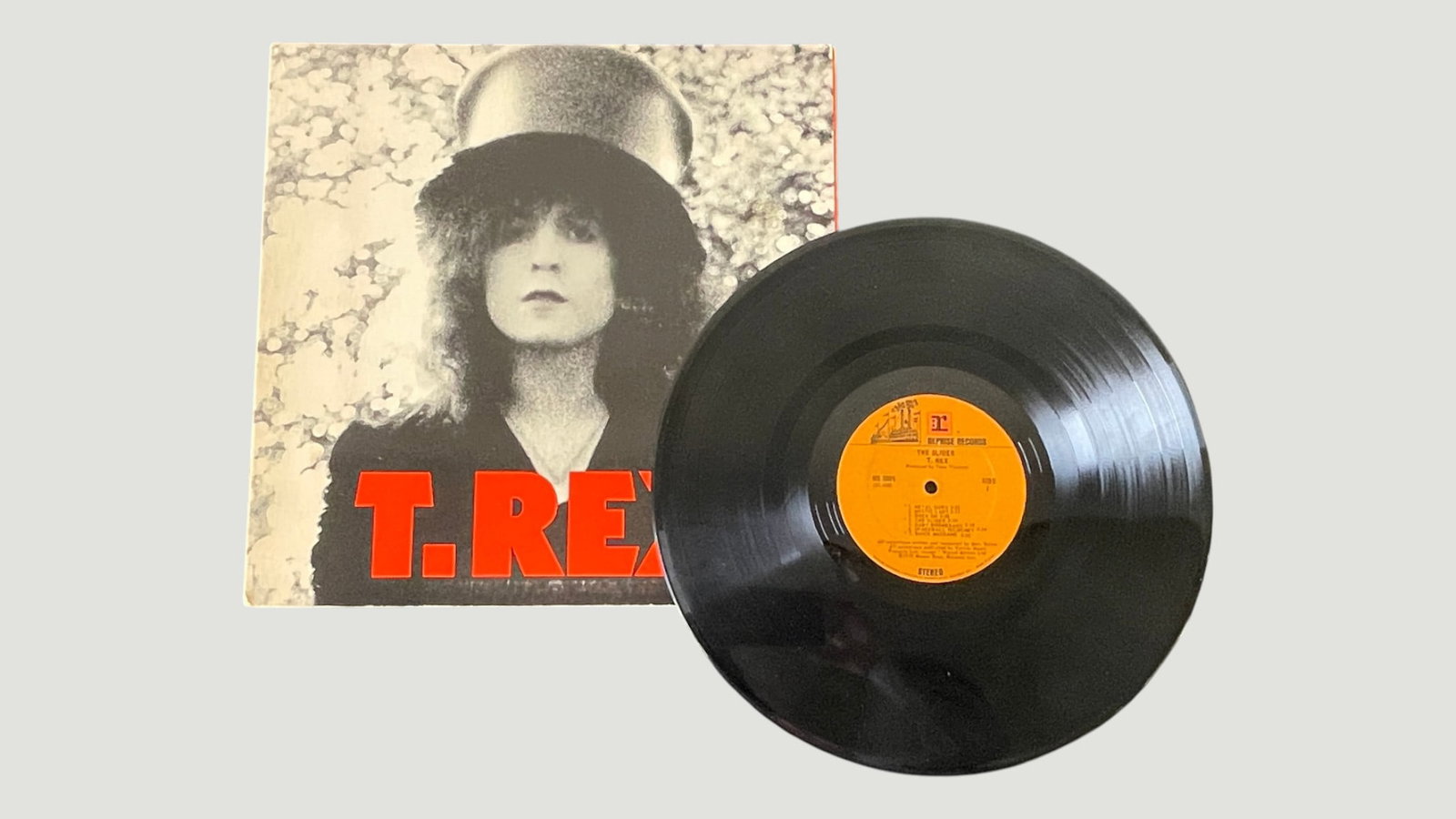 T. Rex 'The Slider' Vinyl LP Record Album, Fly/Hi-Price Records, 1972: Original pressing of T. Rex's iconic glam rock album 'The Slider,' released in 1972 on the Hi-Price/Fly Records label, featuring the distinctive orange label with the steamship logo. The album was pro