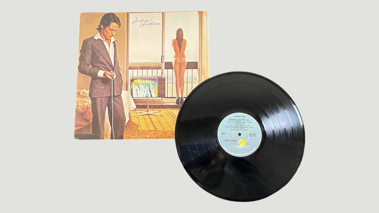 Robert Palmer 'Pressure Drop' Vinyl LP, Island Records, 1975: This is Robert Palmer's second studio album 'Pressure Drop,' released in 1975 on Island Records (ILPS 9372). The album features a distinctive cover artwork depicting a hotel room scene, typical of the