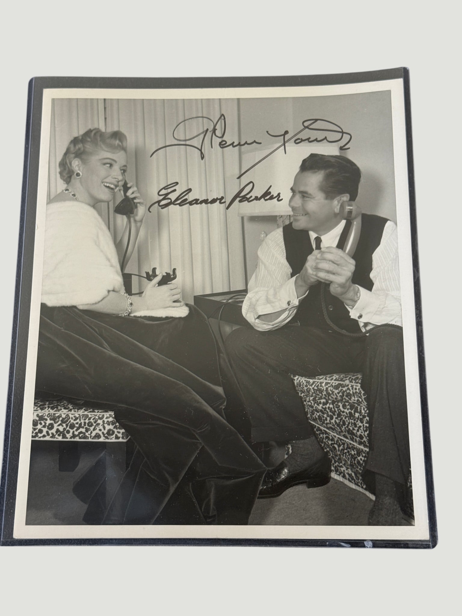 Glenn Ford & Eleanor Parker Dual Signed Vintage 8x10 Black & White Photo: A vintage black and white 8x10 promotional or candid photograph signed by two major Hollywood stars: Glenn Ford and Eleanor Parker. The photo depicts a man and woman in mid-century formal attire, laug