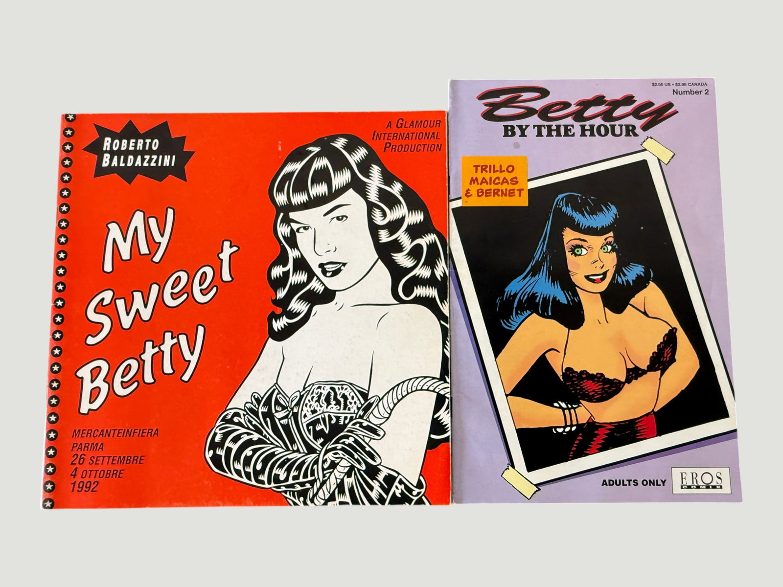 Betty Page Comics Lot: My Sweet Betty (1992) & Betty By The Hour #2, Eros Comix: A pair of Betty Page-themed adult comics publications. The first is 'My Sweet Betty' by Roberto Baldazzini, a Glamour International Production catalogue/publication issued for the MercanteInFiera Parm