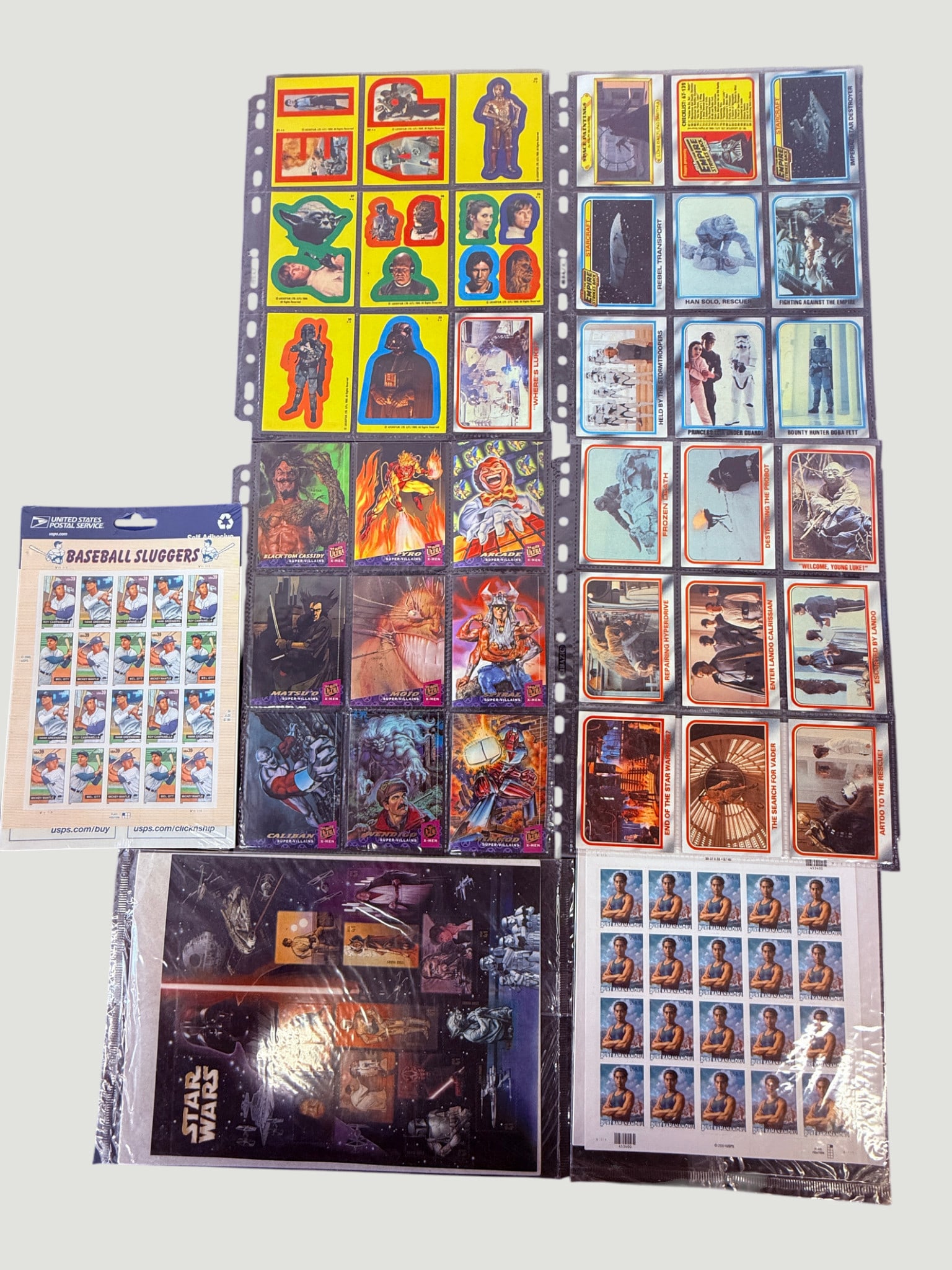 Star Wars & Mixed Collectibles Lot: Trading Cards, Stickers, USPS Stamps 1980s-2000s: A diverse collection of Star Wars related collectibles spanning multiple decades, including 1980 Topps Empire Strikes Back trading cards (Series 2, orange border), Empire Strikes Back sticker cards, w