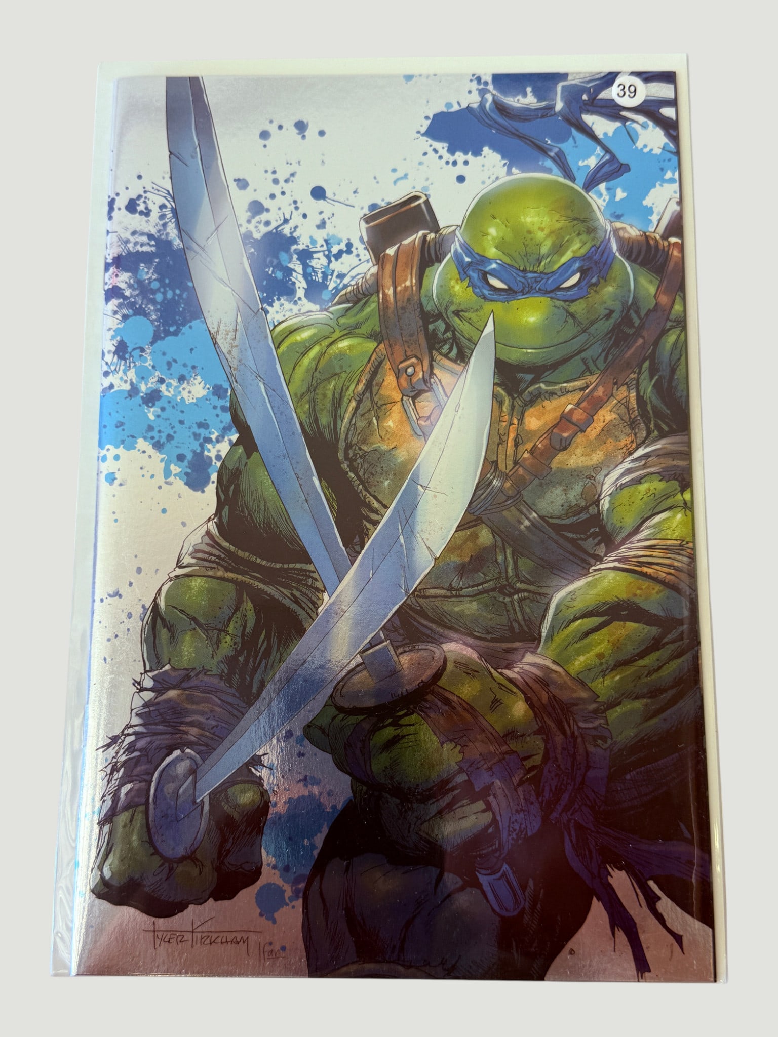 TMNT Leonardo Variant Cover Comic #39 Signed Tyler Kirkham Art Print/Cover: A striking Teenage Mutant Ninja Turtles variant cover or art print featuring Leonardo, identifiable by his blue mask and signature twin katana blades, rendered in a dramatic close-up composition with 