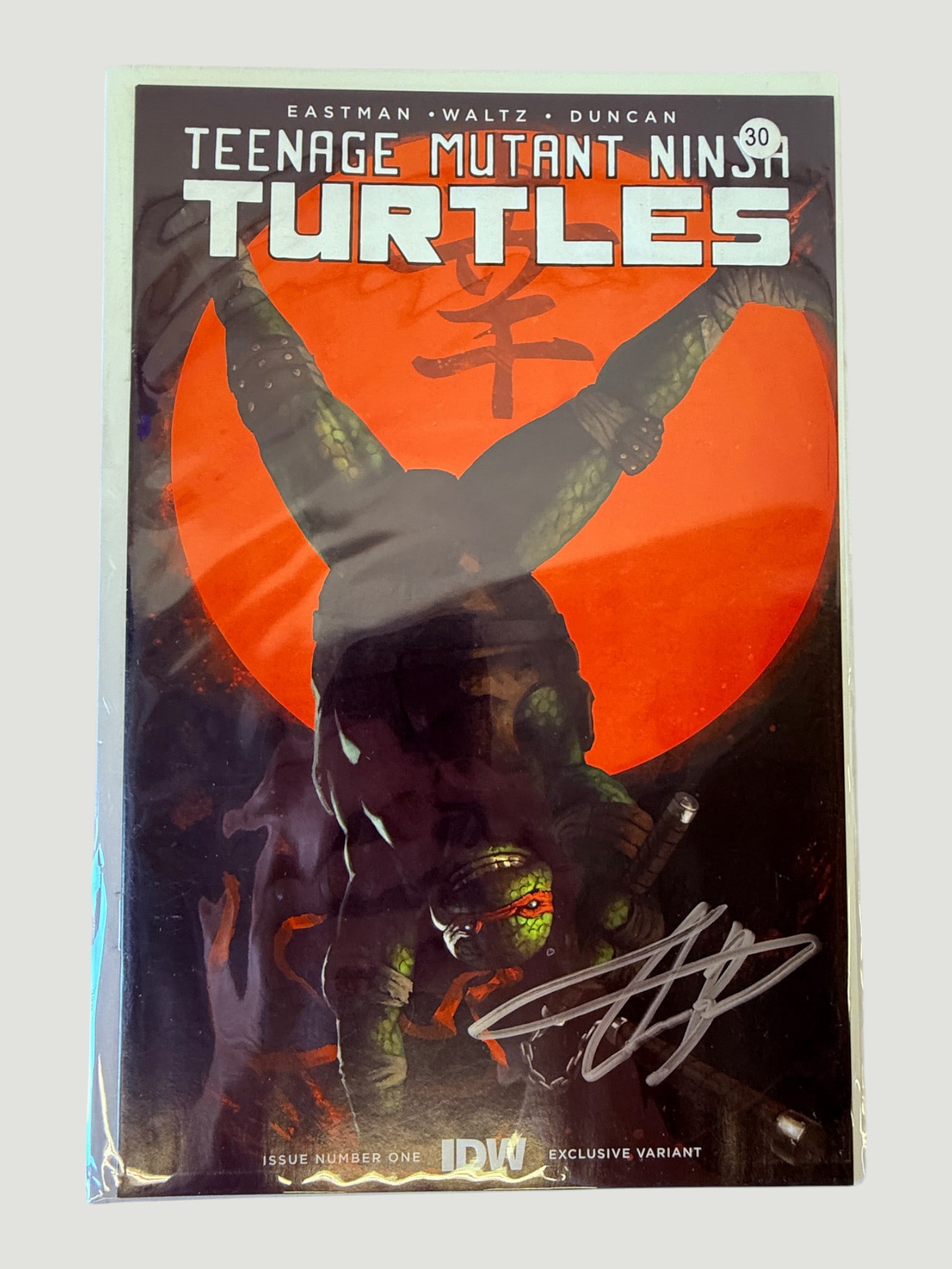 TMNT #1 IDW Exclusive Variant #30 Signed — Eastman, Waltz & Duncan: Teenage Mutant Ninja Turtles Issue Number One, IDW Publishing Exclusive Variant, numbered 30, by Kevin Eastman, Tom Waltz, and Duncan. This is a limited exclusive variant edition featuring a striking 