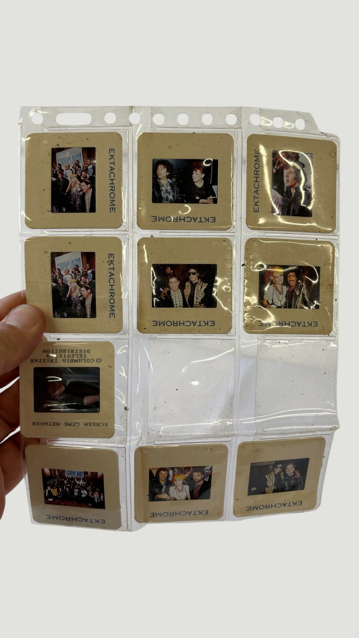 Vintage Ektachrome 35mm Photo Slides – Celebrity Events, Columbia TriStar, c.1980s: A collection of approximately 10 Kodak Ektachrome 35mm color transparency slides housed in a plastic sleeve sheet, appearing to document celebrity or entertainment industry events from the 1980s.
