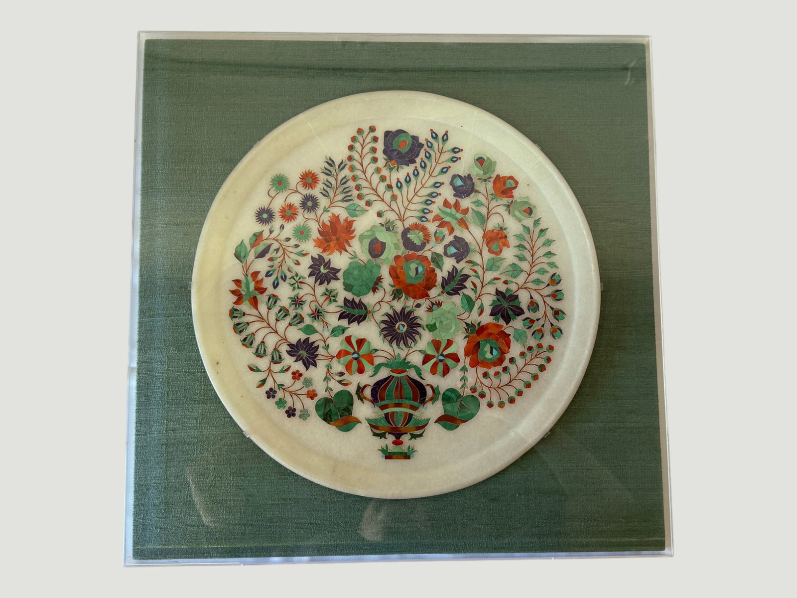 Indian Pietra Dura Marble Inlay Circular Panel, Mughal Floral Design, Agra: A finely crafted Indian pietra dura (parchin kari) circular white marble panel featuring an elaborate polychrome hardstone inlay composition of flowering vines, blooms, and foliage radiating from a ce