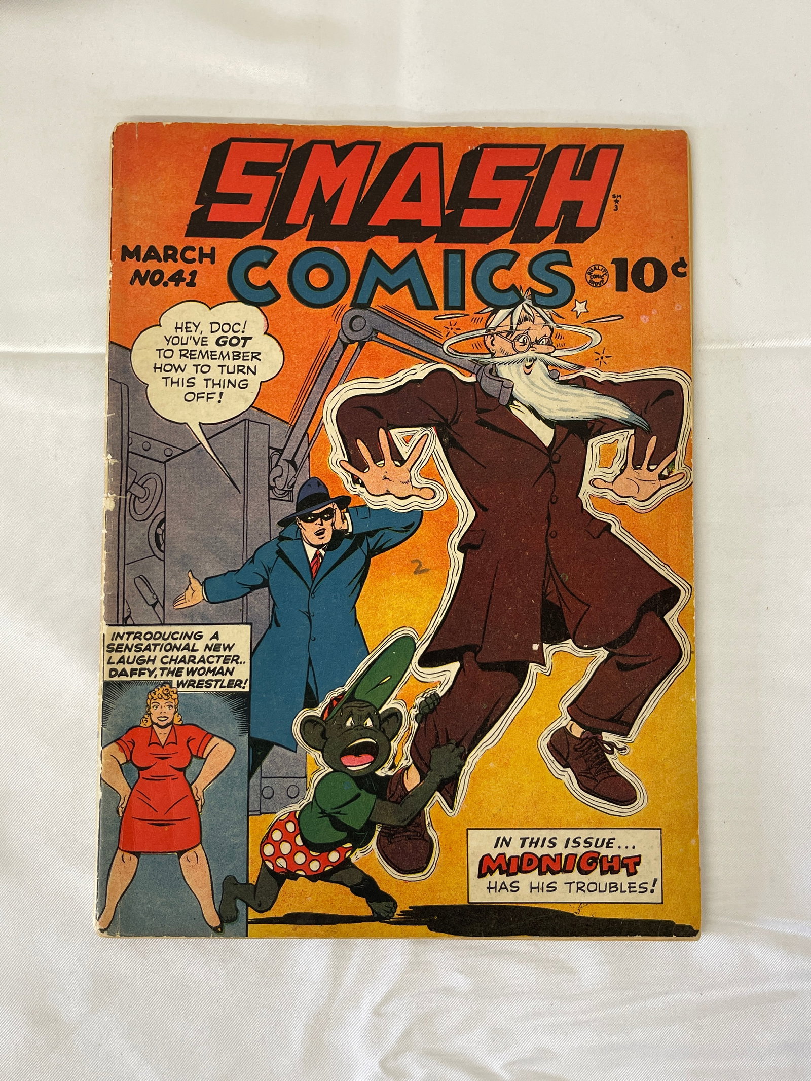 Smash Comics #41 (Quality Comics, March 1943) – Midnight Cover: Smash Comics #41, published by Quality Comics in March 1943, featuring a dynamic cover showcasing the masked hero Midnight in action alongside a chaotic scene involving a mad scientist and a