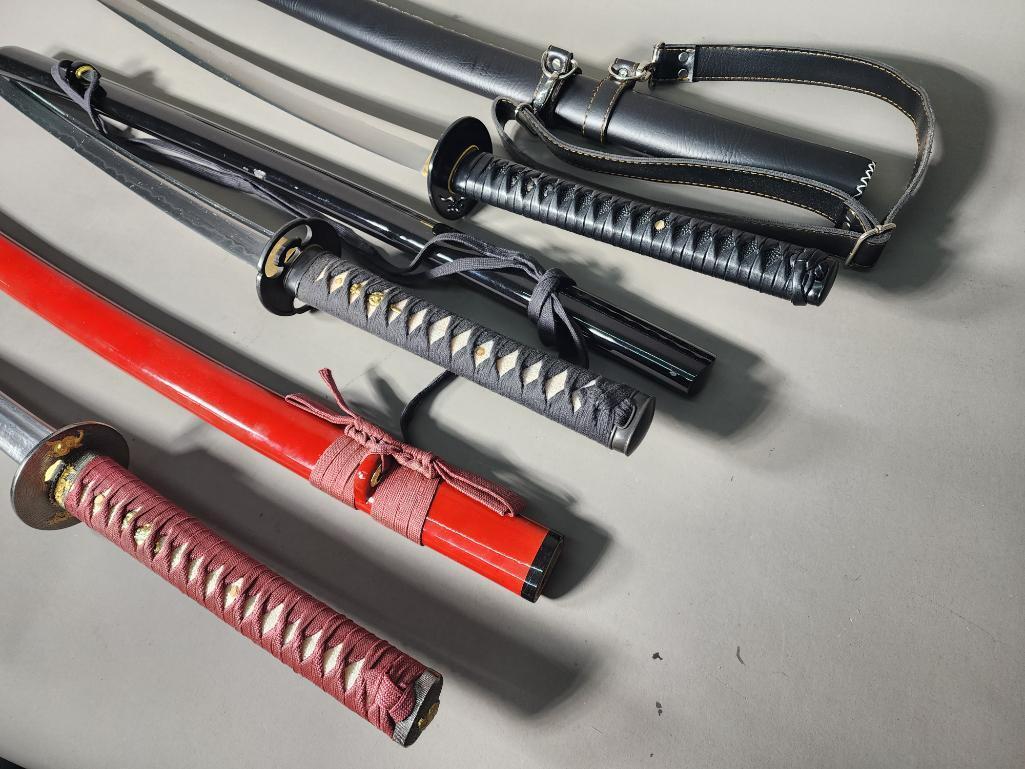Three Katana Style Swords - Red and Black with Sheaths: Three Katana Style Swords - Red and Black with Sheaths. In-house shipping available. Pickup is Monday, March 13th from 11am to 6pm in Carroll, Ohio 43112 or we will provide in-house shipping for this 