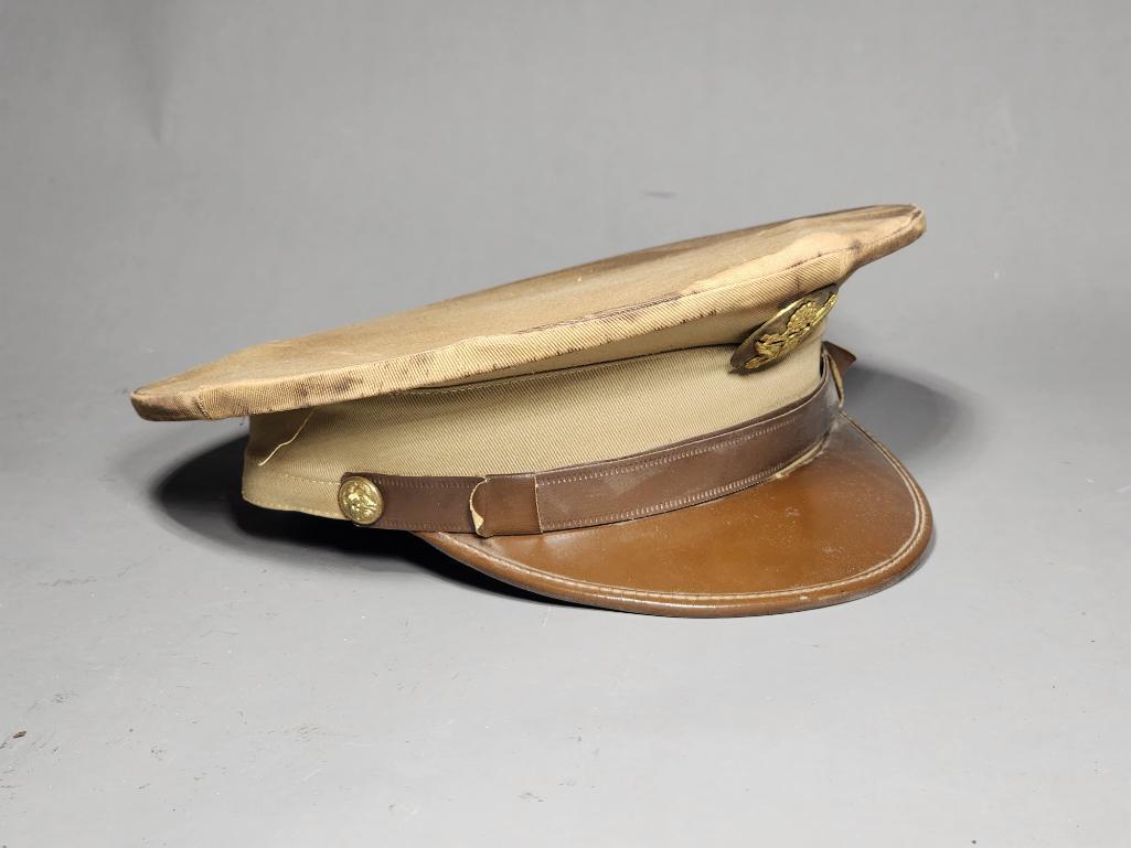 WWII Era Army Peaked Cap in Khaki w/Insignia: SHIPPING: In-house shipping available. Pickup is Monday, June 5 from 2 pm to 7 pm and Tuesday, June 6 from Noon to 5 pm in Carroll, Ohio 43112 or we will provide in-house shipping for this item. Sales