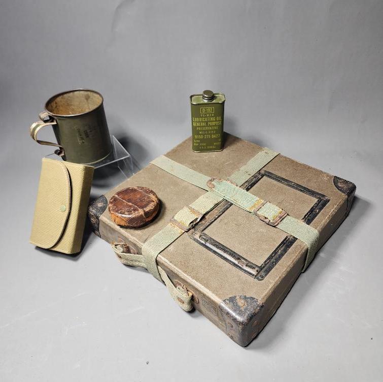 Group lot of WWII Era Military Items including Sewing Kit: Film reel box, cup, oil. SHIPPING: In-house shipping available. Pickup is Monday, June 5 from 2 pm to 7 pm and Tuesday, June 6 from Noon to 5 pm in Carroll, Ohio 43112 or we will provide in-house ship