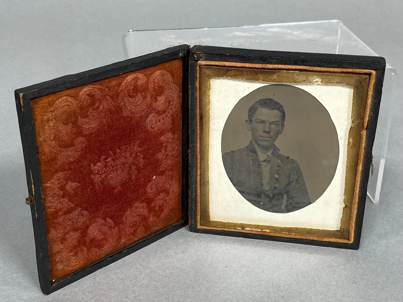 CIVIL WAR IDED CONFEDERATE - MILITIA AMBROTYPE: 1/6th plate ambrotype featuring a soldier wearing an eight button shell jacket with dark collar and cuffs. The backing paper bears the inscription: "Miss Luu E. Mavis (Harris?) Union Mills Va. May 13t