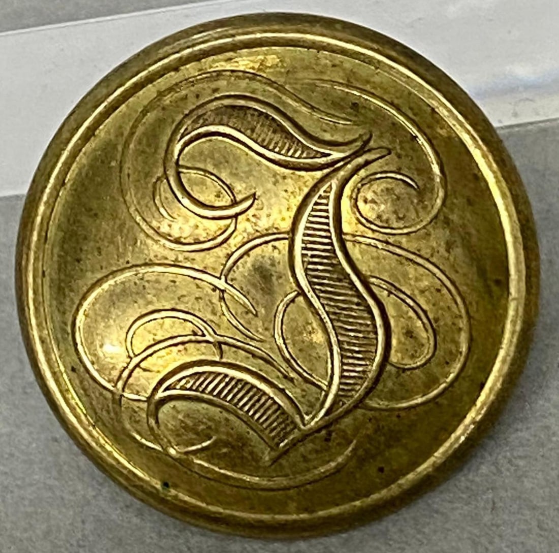 CIVIL WAR CONFEDERATE INFANTRY BUTTON: Civil War Confederate Infantry Script "I" button - non dug, two piece with border. "Halfmann & Taylor / Montgomery". Coat size button 23mm. Button is CS 175 in Albert's book and CSI212A2 in Tice's boo