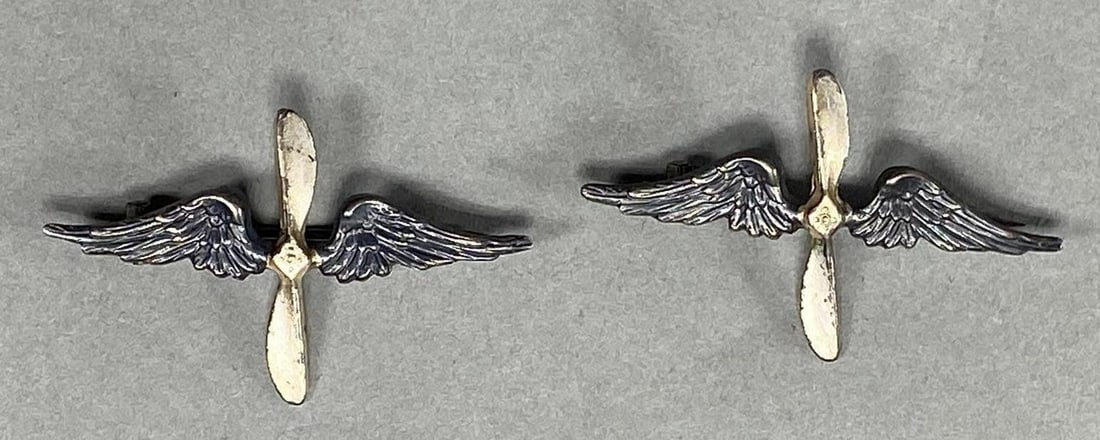 WWI US ARMY AIR SERVICE FRENCH MADE INSIGNIA: Matching pair of World War One French made U.S. Army Air Service Wing and prop collar insignia. Each device measures 1 15/16" x 1 1/8". The pin back attachment devices have an open "C hook" catch. WW1