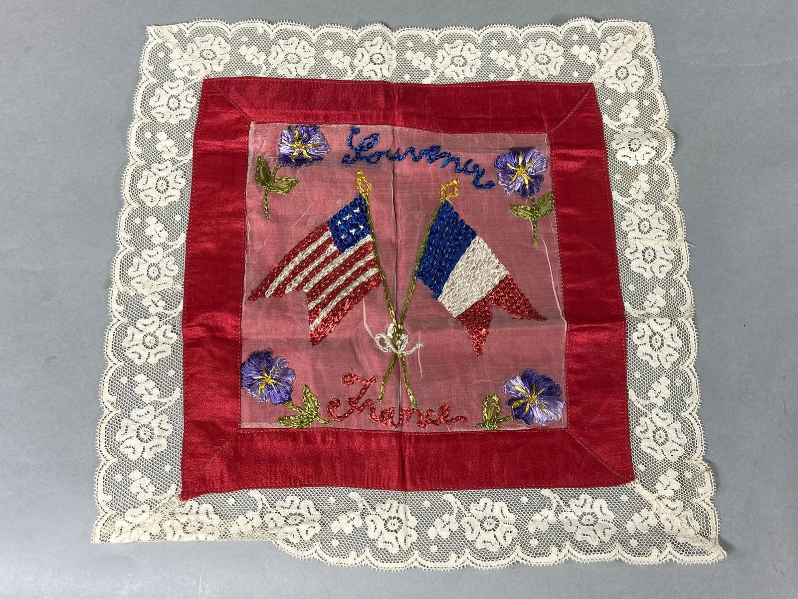 WWI SOUVENIR OF FRANCE EMBROIDERED HANDKERCHIEF: Excellent condition World War One doughboy souvenir handkerchief with embroidered center and lace trim. Measures 13 1/2" x 13 1/2" In-house shipping is available. Pickup is Thursday, Oct. 19 and Frida