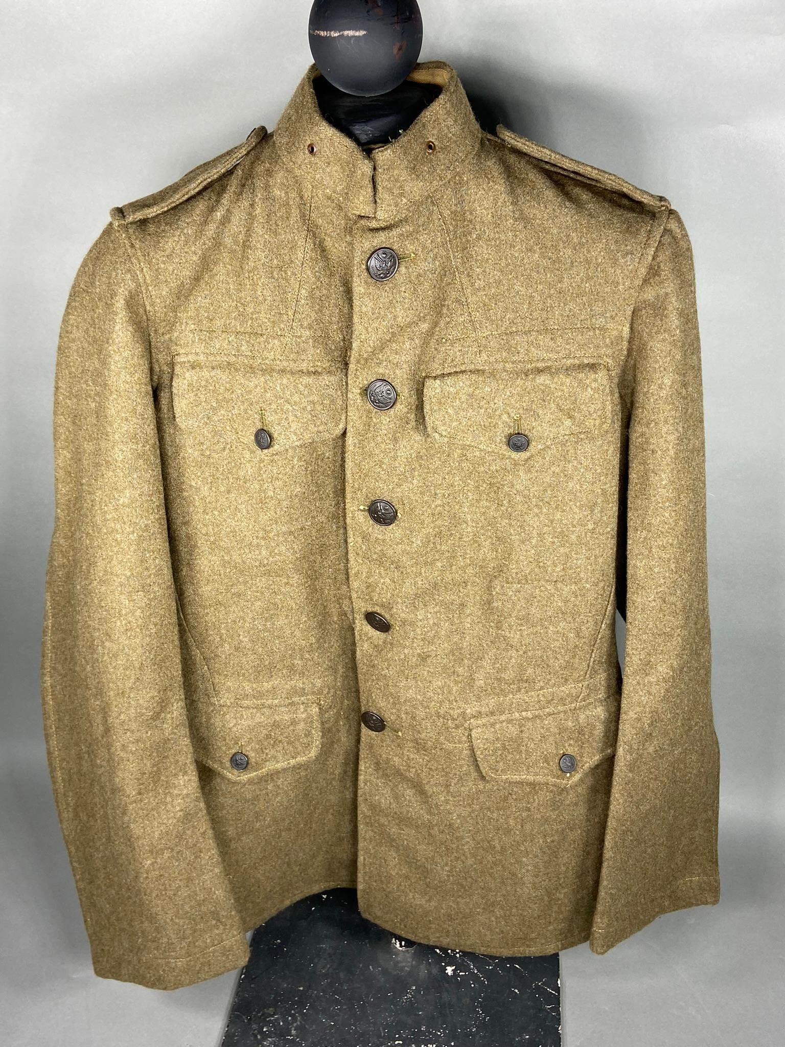 WWI BRITISH MADE U.S. ARMY 1918 TUNIC - COAT: World War One British made 1918 pattern United States Army Tunic. This coat is identical to the U.S. made 1918 tunics with the exception that there is no lining and there are British stampings 209 W (