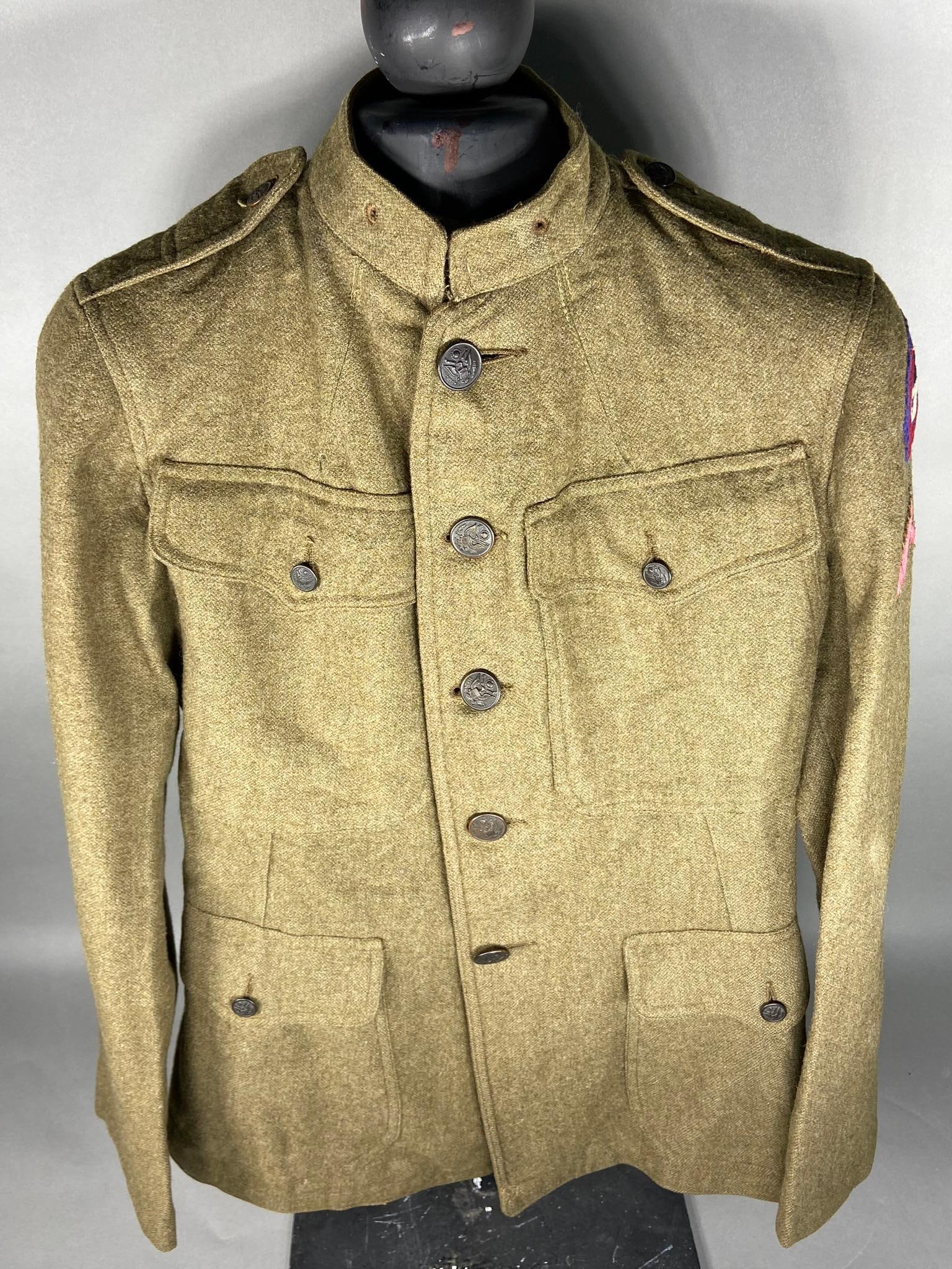 WWI US ARMY 13TH DIVISION TUNIC - IDENTIFIED: World War One 1917 pattern service coat - tunic. A multi piece 13th Division patch is sewn to the left shoulder directly above the honorable discharge stripe. The name "Kent" is written on the inside 