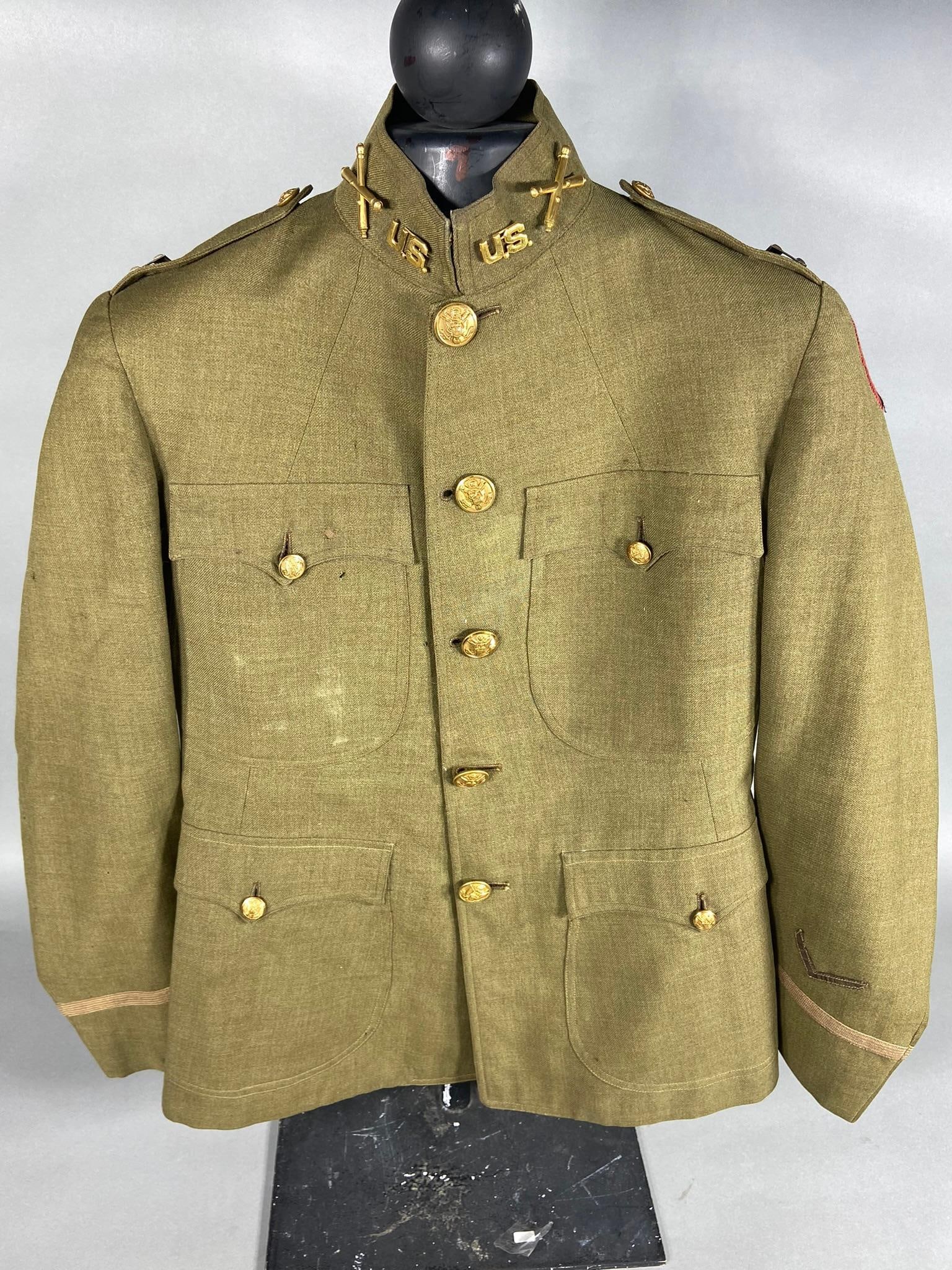 POST WWI 7TH DIVISION OFFICER TUNIC: Post World War One 7th Division Captain rank uniform tunic made of a high quality gabardine wool. Affixed to the tunic is a wool two piece 7th Infantry Division patch and inter war period insignia. Th