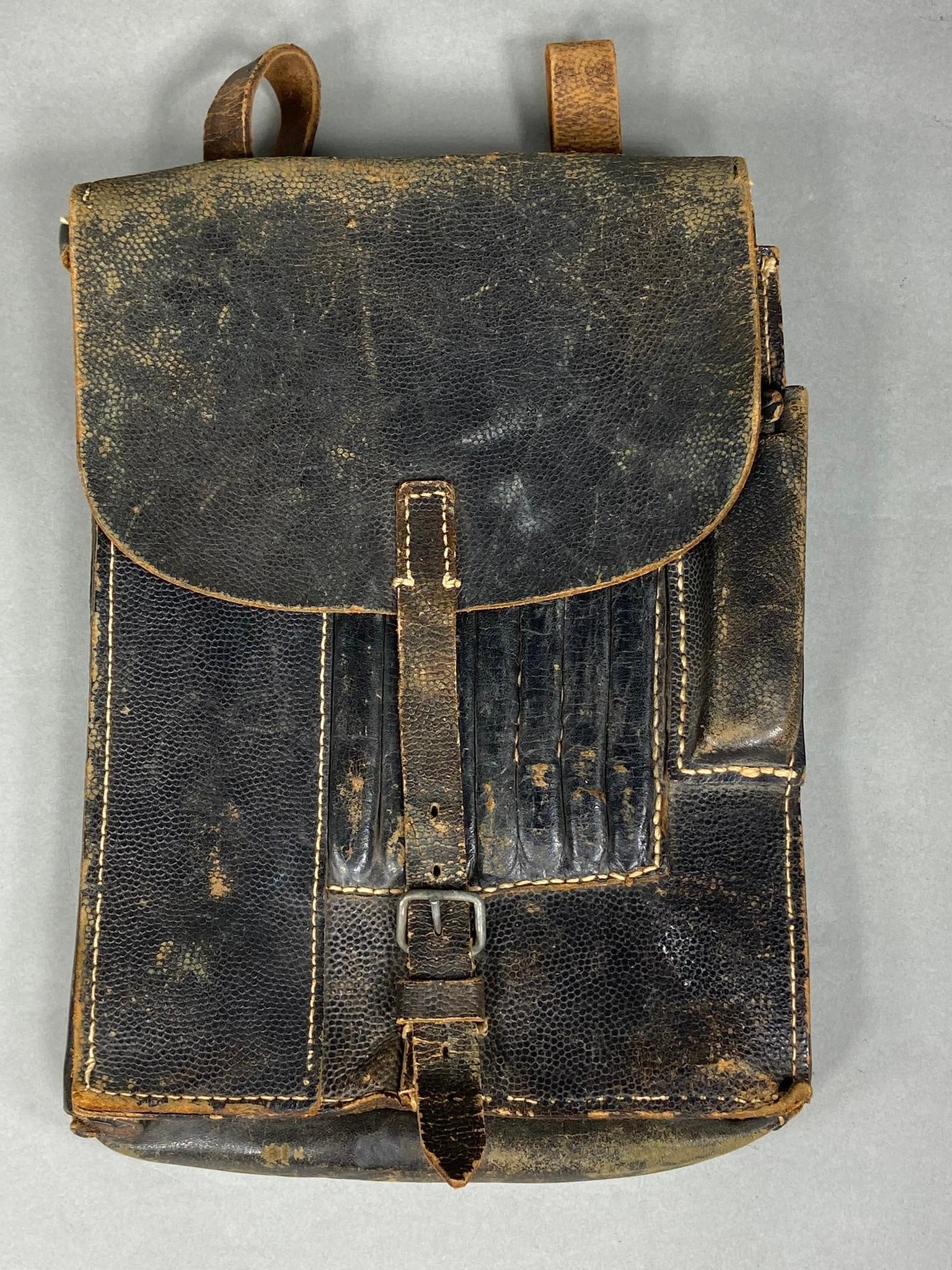 WWII NAZI GERMAN MAP CASE - IDENTIFIED: World War Two black pebbled leather map case. Identified on the underside of the flap; two different names are written. Between the names is a series of stamped numbers. Leather is very pliable and su