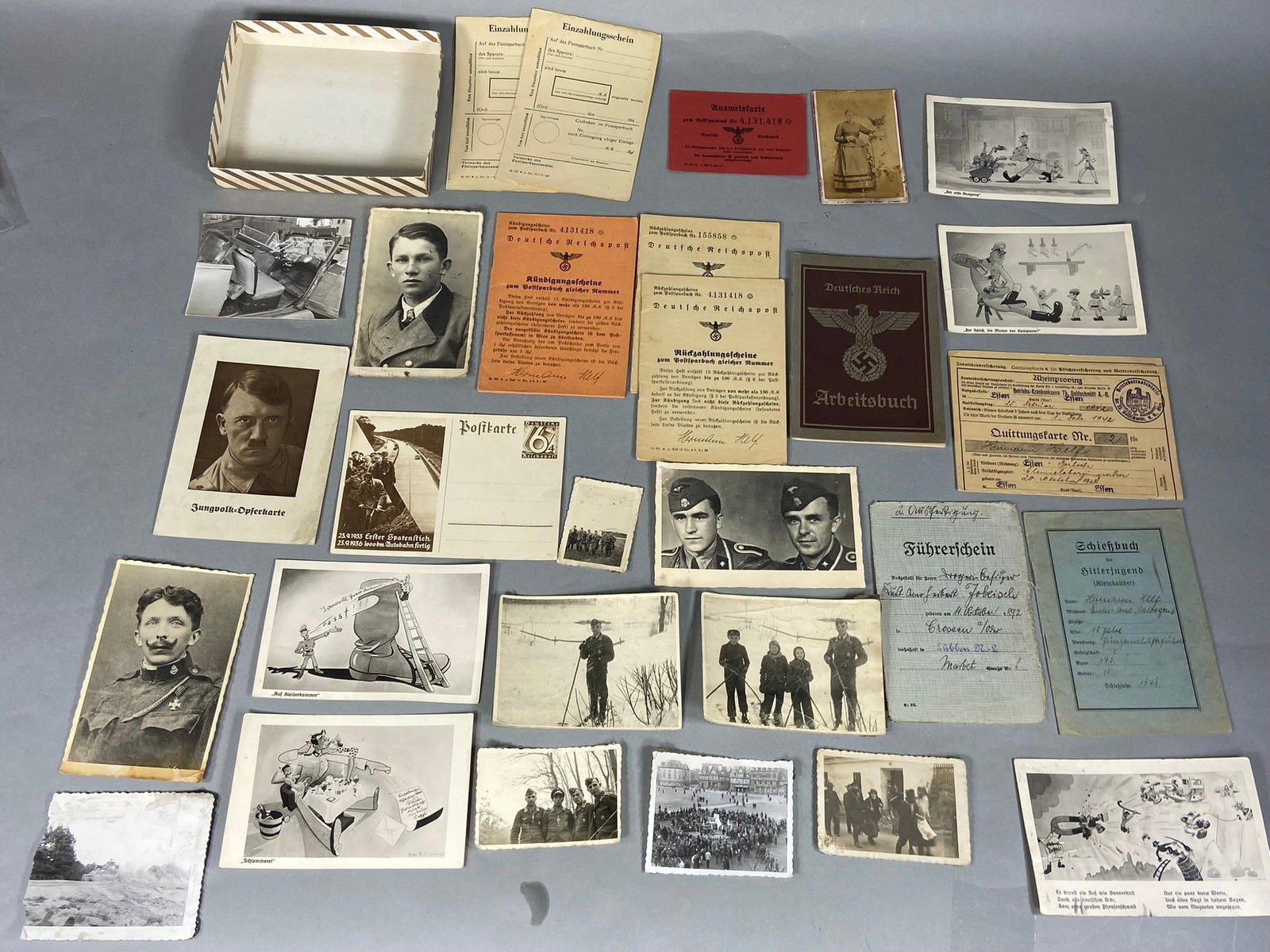 WWII NAZI GERMAN PHOTO & EPHEMERA LOT SS: World War Two Nazi German photograph & ephemera group. Included in the photographs are SS soldiers and a luftwaffe crew with cold weather gear. there are a number of humorous postcards, an arbeitsbuch