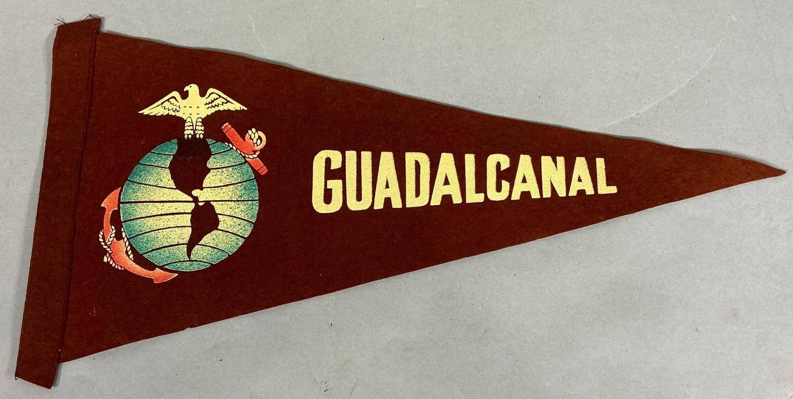 WWII USMC AUSTRALIAN MADE GUADALCANAL PENNANT: Excellent condition World War Two WW2 Australian made United States Marine Corps Guadalcanal felt pennant. Measures 17.5" x 9". In-house shipping is available. Pickup is Thursday, Oct. 19 and Friday O