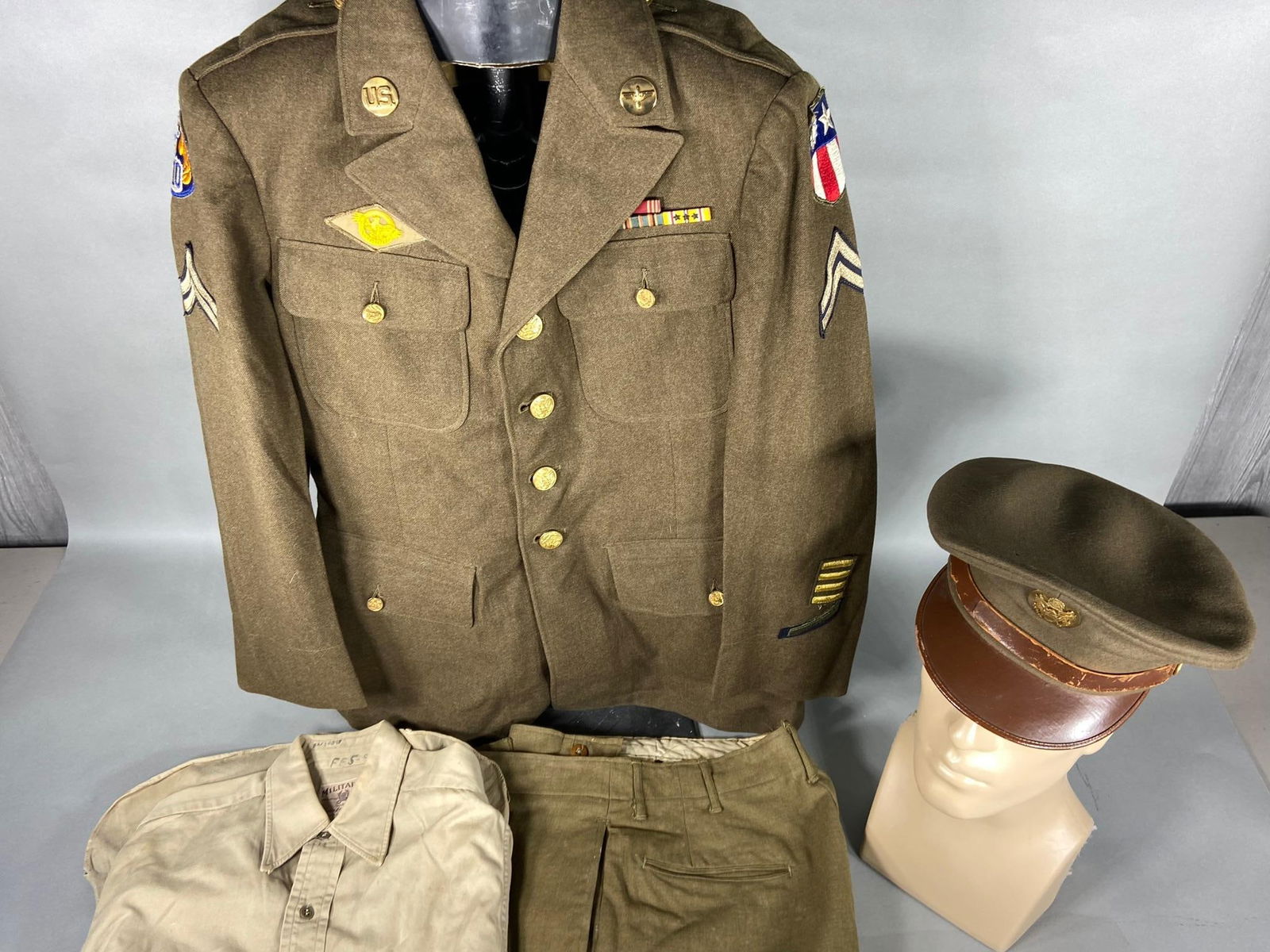 WWII U.S. ARMY CBI 10TH ARMY AIR FORCE UNIFORM: World War Two CBI uniform including 4 pocket Class A tunic, mustard wool pants with button fly, custom made khaki shirt, and enlisted visor cap. The tunic has a faded but still visible laundry tag num