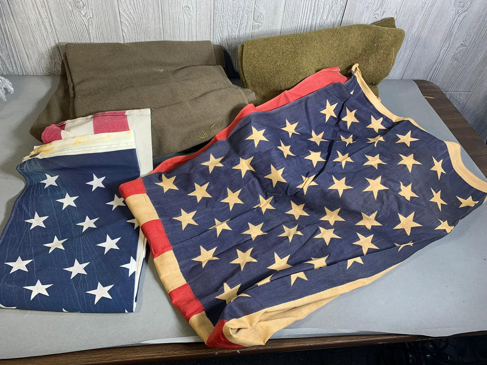 Vintage US Flags and Military Blankets: Vintage US Flags and Military Blankets. To see up to 100 photos of this lot, please find this sale on LiveAuctioneers. In-house shipping is available. Pickup is Friday, April 5th from 12pm to 7pm in C