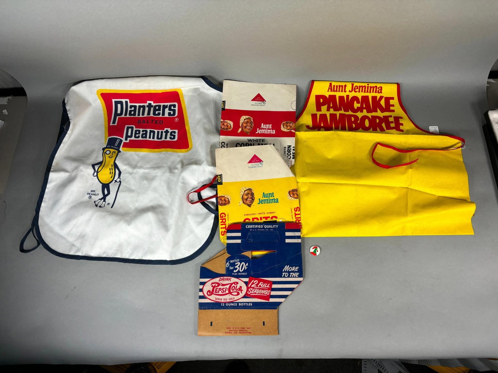 Lot of Food and Drink Advertising and Carriers including Planters Peanuts, Aunt Jemima, and Pepsi: Lot of Food and Drink Advertising and Carriers including Planters Peanuts, Aunt Jemima, and Pepsi. To see up to 100 photos of this lot, please find this sale on LiveAuctioneers. In-house shipping is a